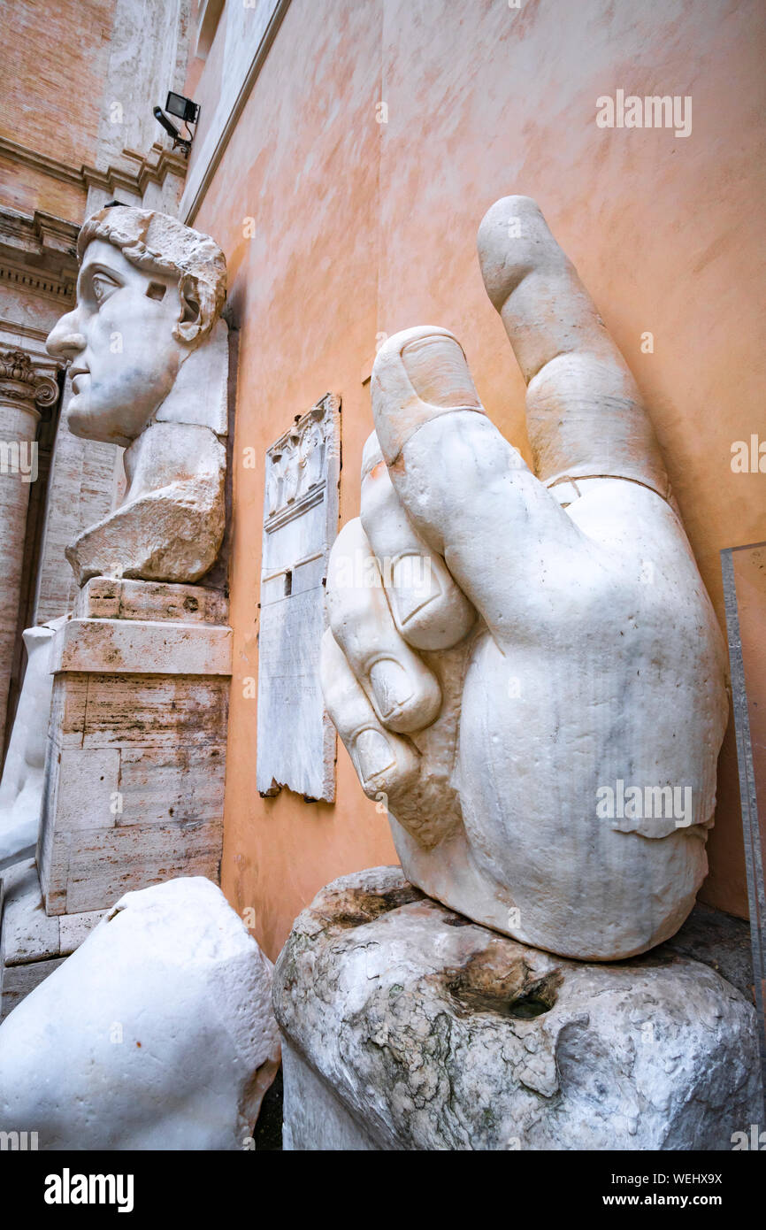 The head and hand of the Colossus of Constantine in the courtyard of the Palazzo dei Conservatori, part of the Capitoline Museums,   Rome, Italy. Stock Photo