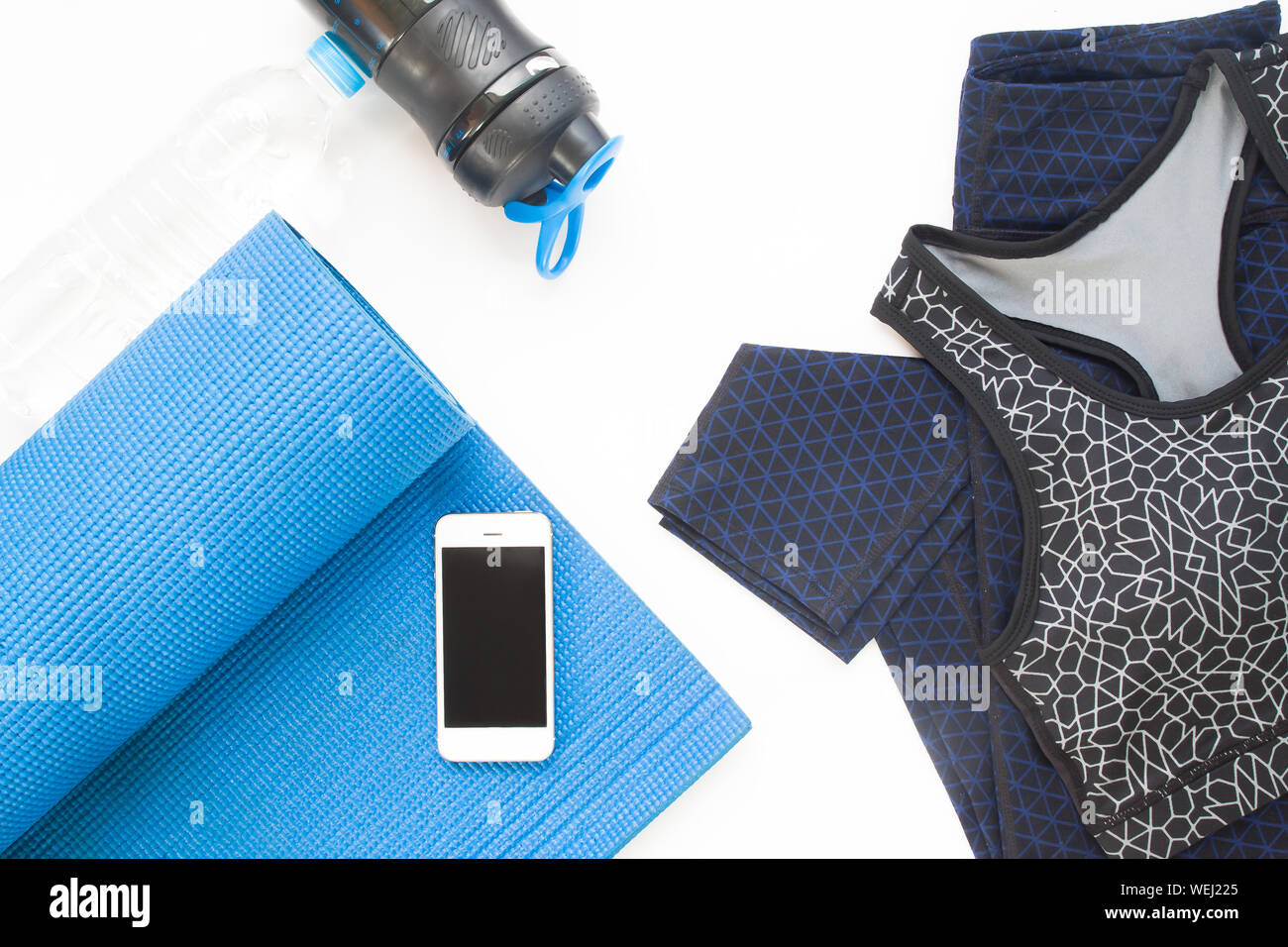 Directly Above Shot Of Smart Phone With Yoga Mat And Sports Clothing Stock Photo