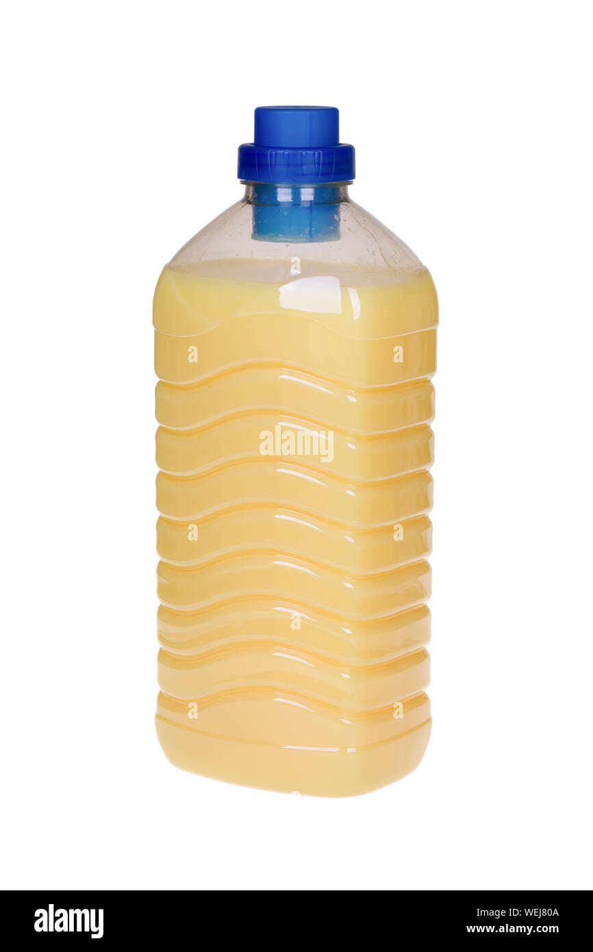 Bottle with yellow fabric softener isolated on white background Stock