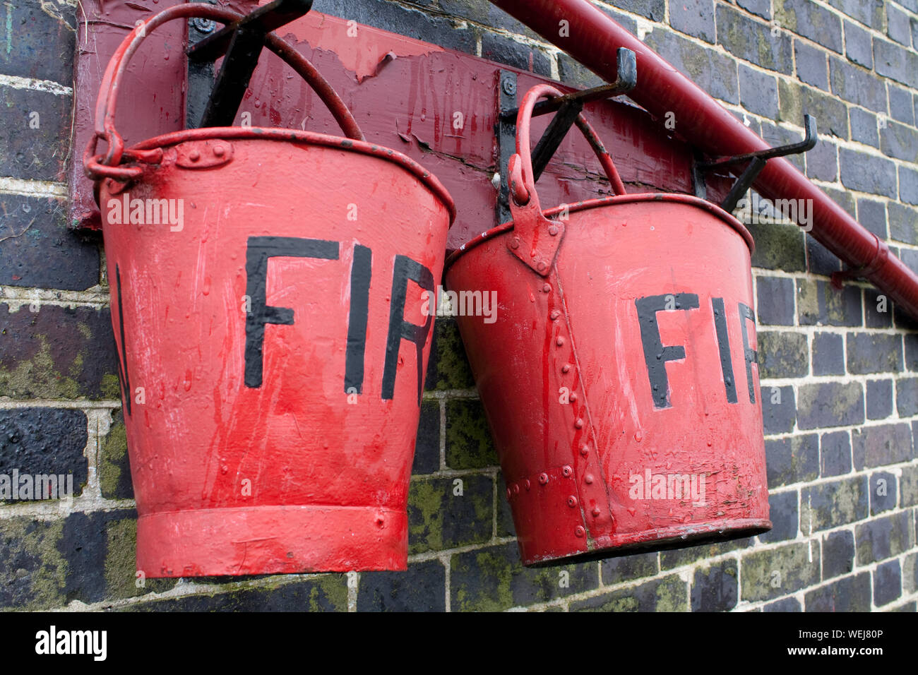 Close-up Of Fire Red Buckets Stock Photo