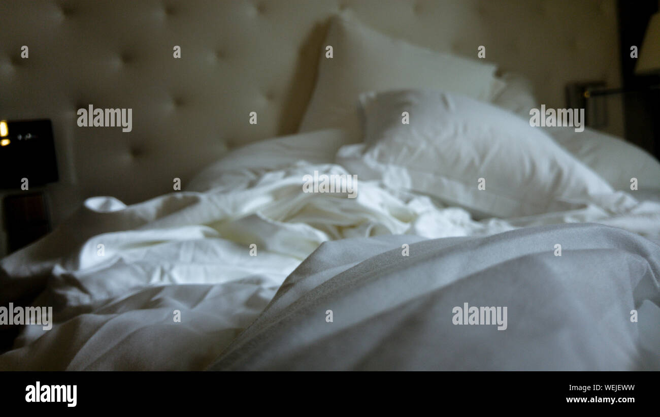 Wrinkled Sheet On Bed At Home Stock Photo