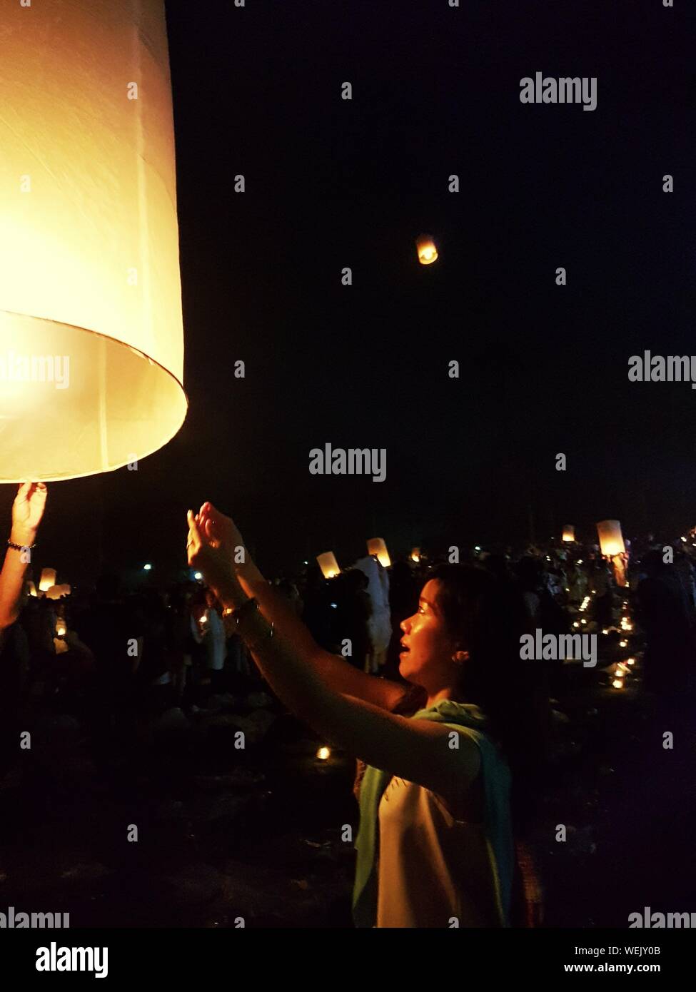 Side View Of Woman Releasing Lanterns At Borobudur Temple Stock Photo