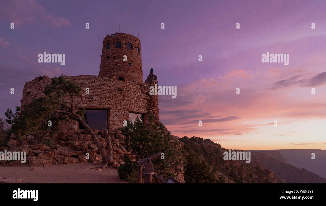 Sunset light hits the primative brick building east side of the south rim in Grand Canyon National park Stock Photo