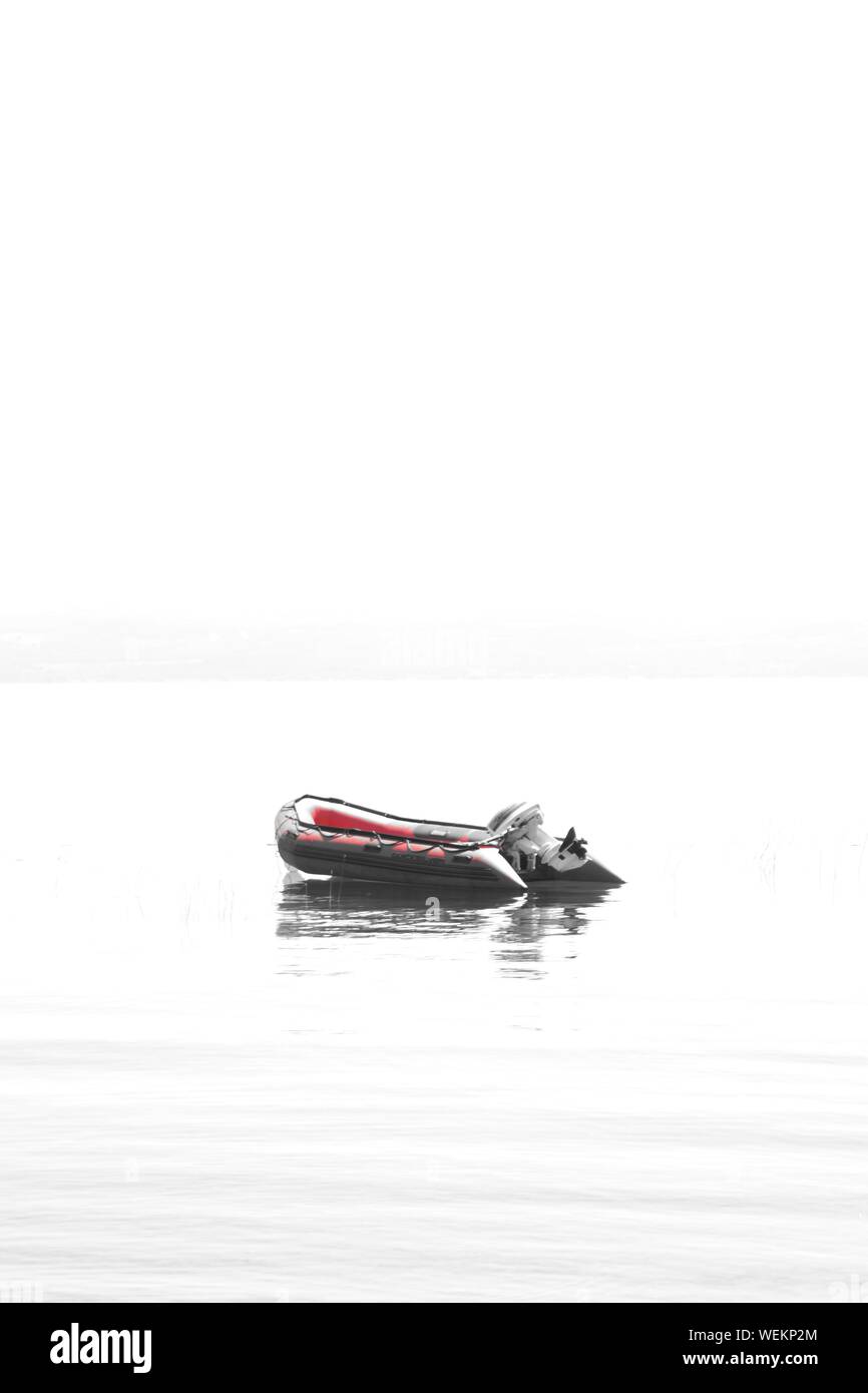 Inflatable Raft On Lake Bolsena Against Clear Sky Stock Photo