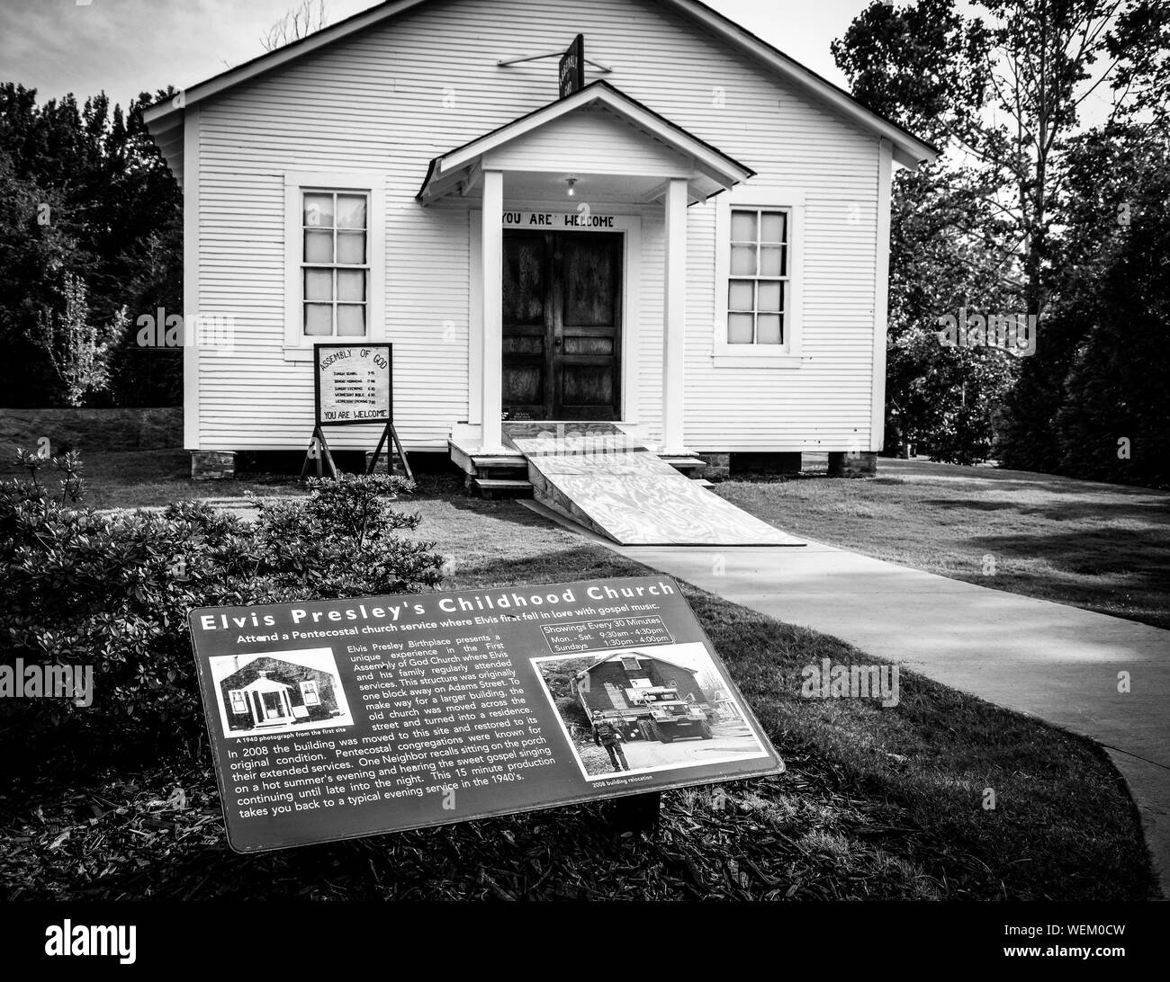 A historical signboard invites fans to Elvis Presley's Childhood Church, moved here to the Grounds of the Elvis Presley Birthplace museum, Tupelo, MS Stock Photo