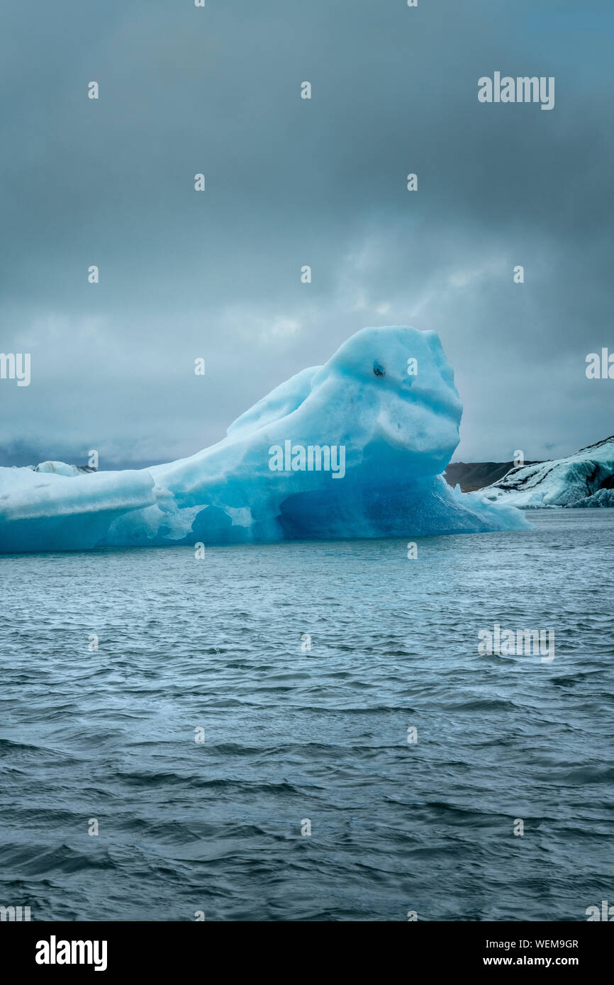 Jökulsárlón lagoon ice formation with iceberg floating in lake, Iceland Stock Photo