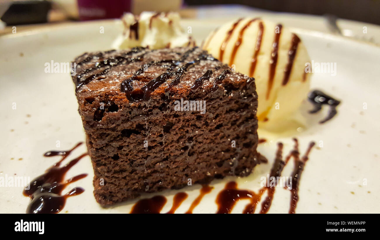 chocolate brownies with ice cream vanilla on a white disk in the restaurant Stock Photo Alamy