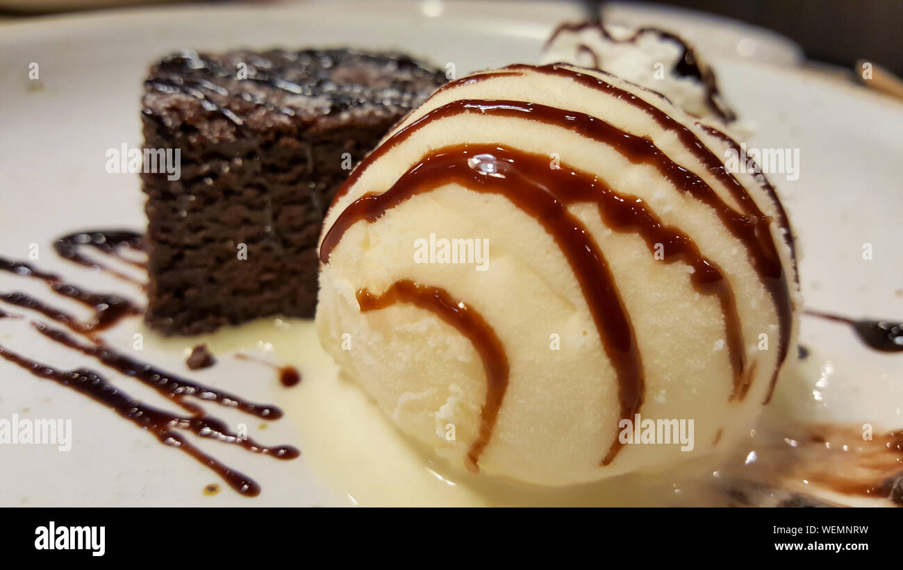 chocolate brownies with ice cream vanilla on a white disk in the restaurant Stock Photo Alamy