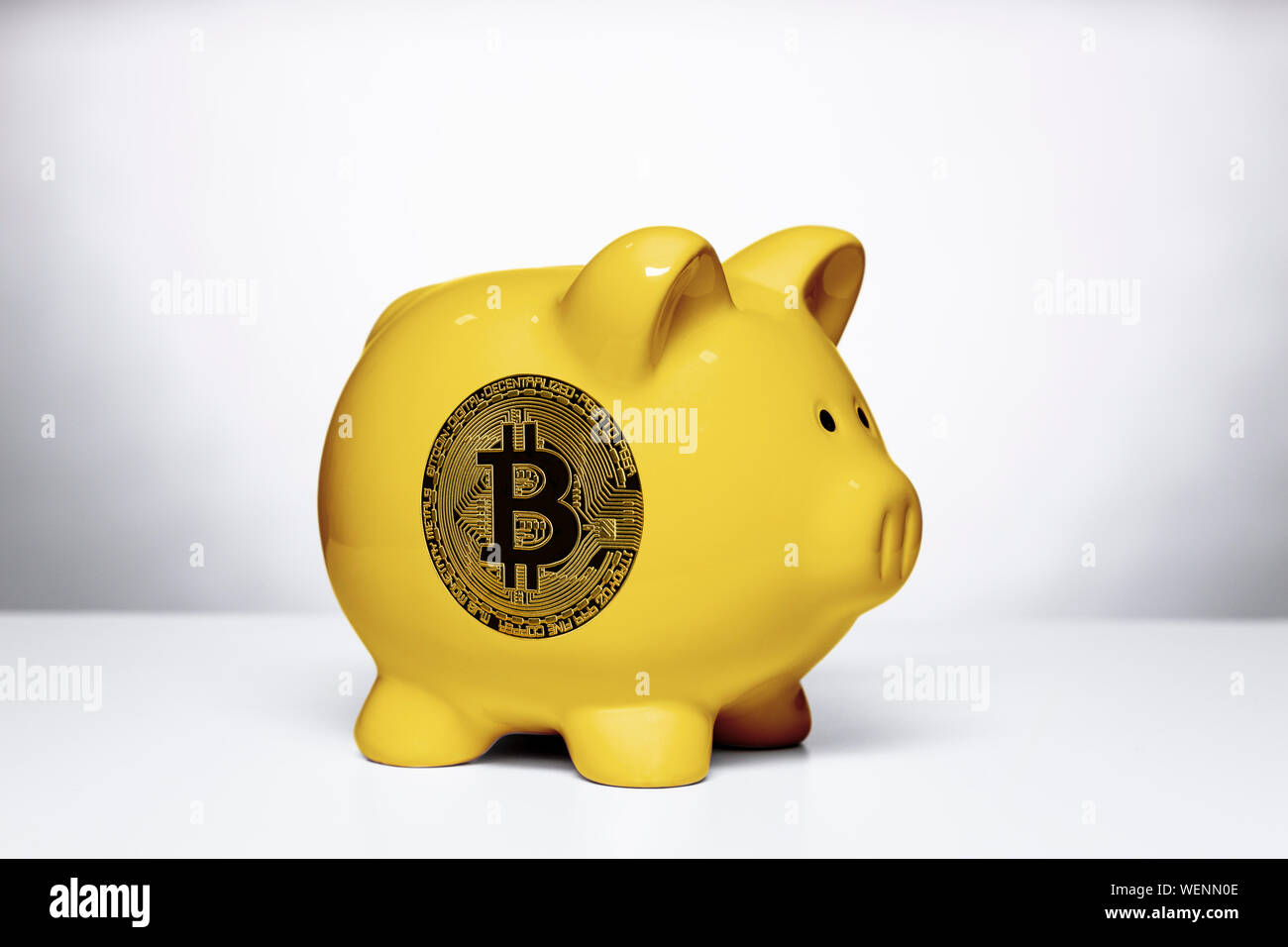 yellow piggy bank with bitcoin symbol on the side, on a white background  Stock Photo - Alamy