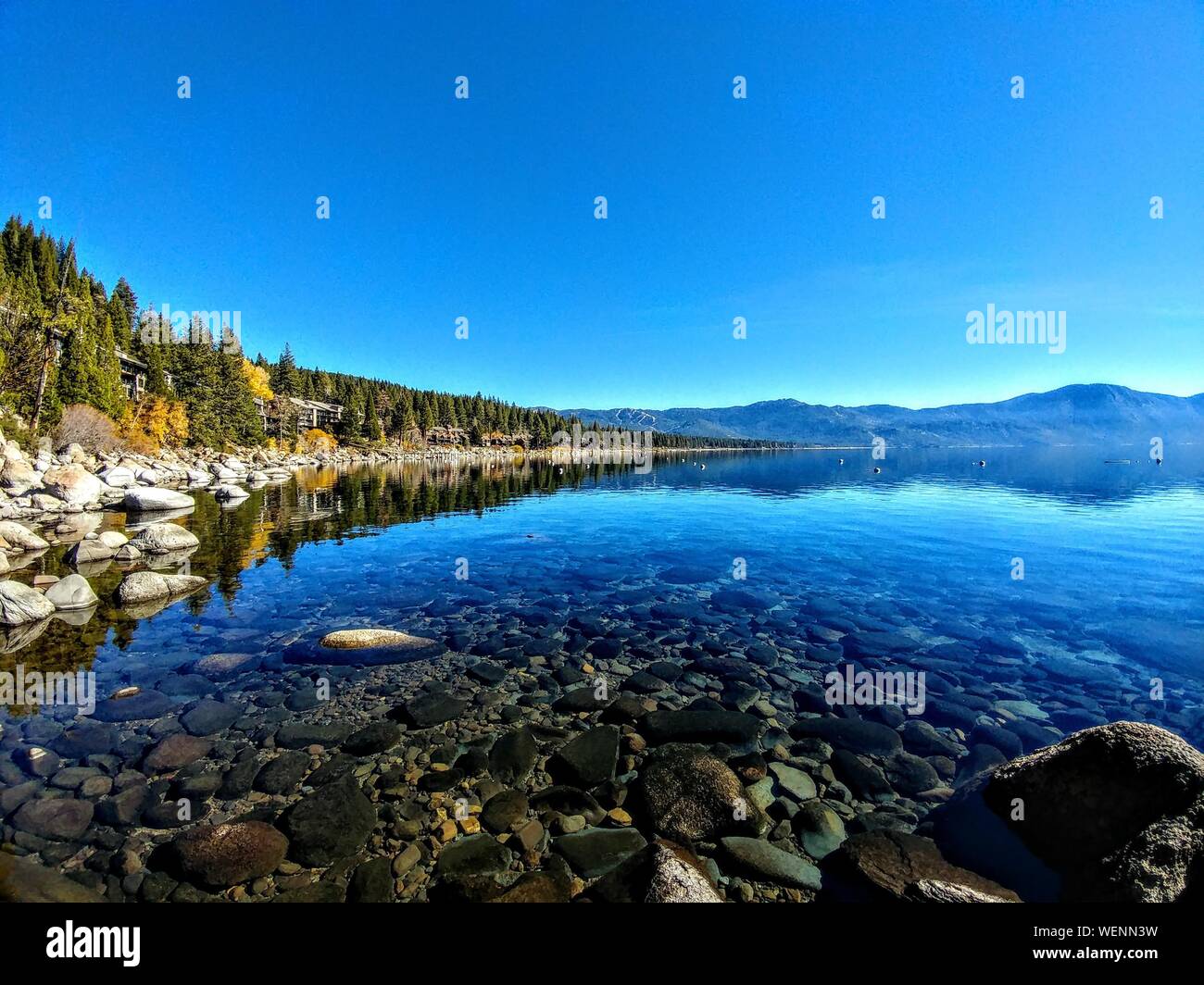 Scenic View Of Lake Tahoe Against Blue Sky At Incline Village Stock Photo