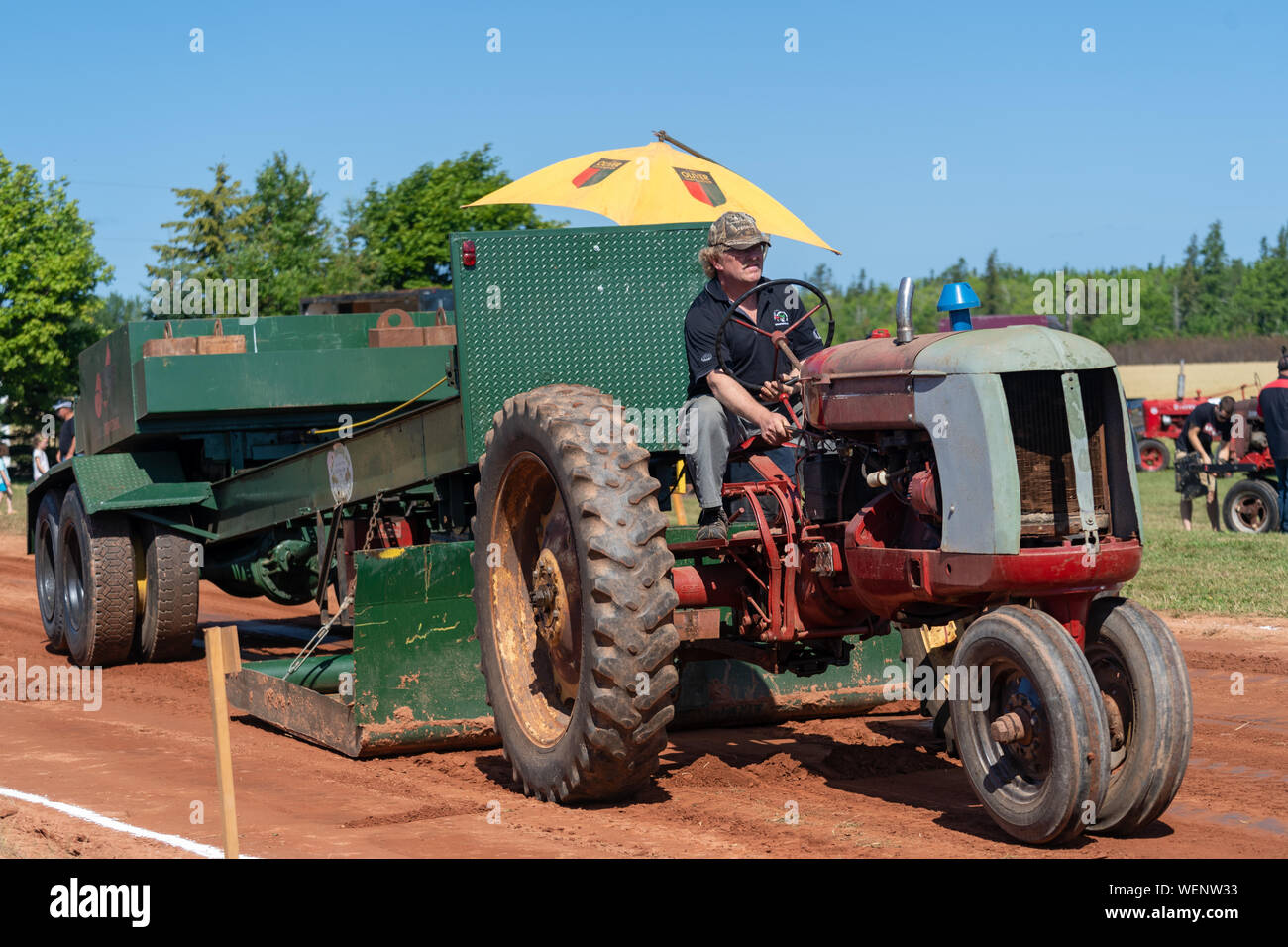 Dundas, Prince Edward Island / Canada - August, 25, 2019: Competitors with their tractors hauling a weighted sled in the annual tractor pull competito Stock Photo