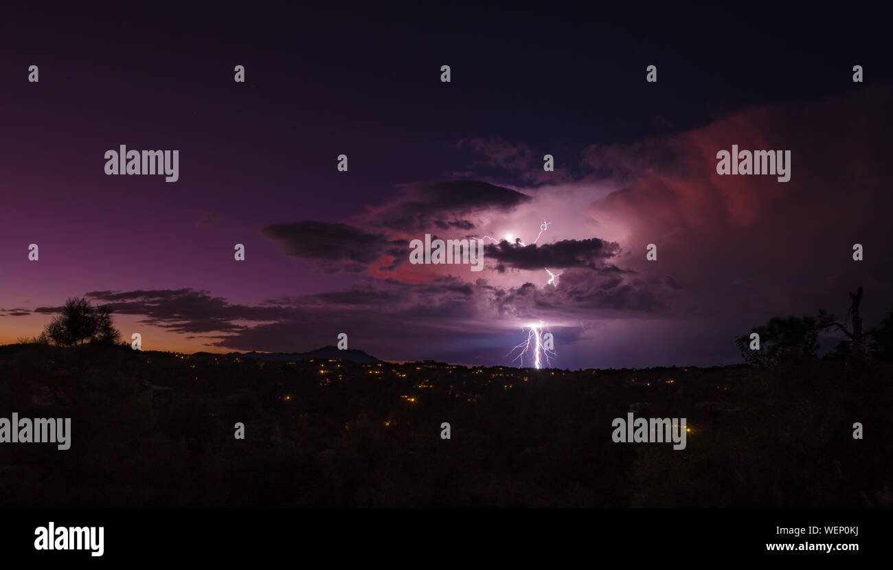 A late summer monsoon brings brilliant colors and dramatic lightning during the evening sunset. Stock Photo