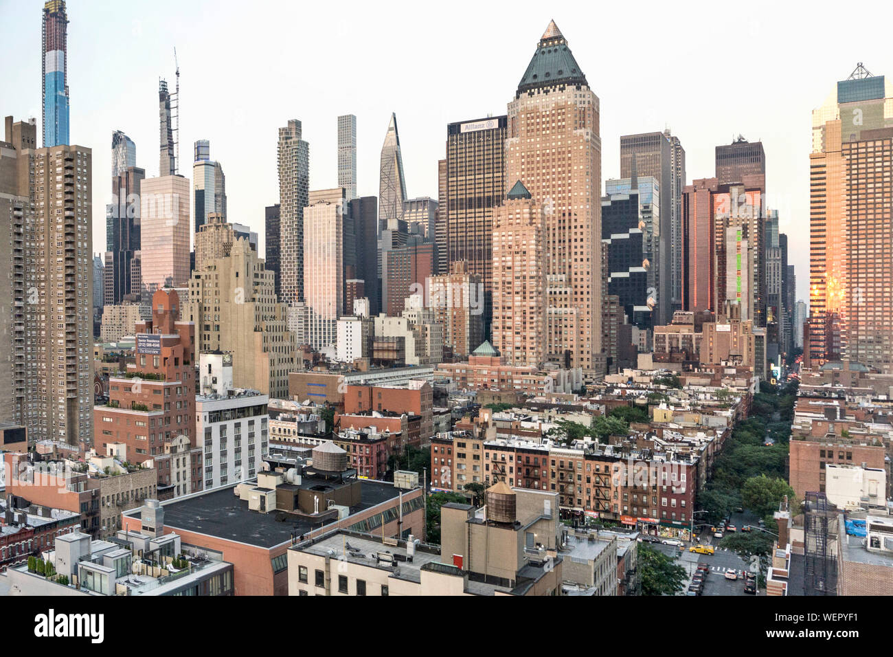 New York midtown skyline with new towers striving ever higher skinny blue sliver at left about to be tallest in US contrast to low roofs Hells Kitchen Stock Photo