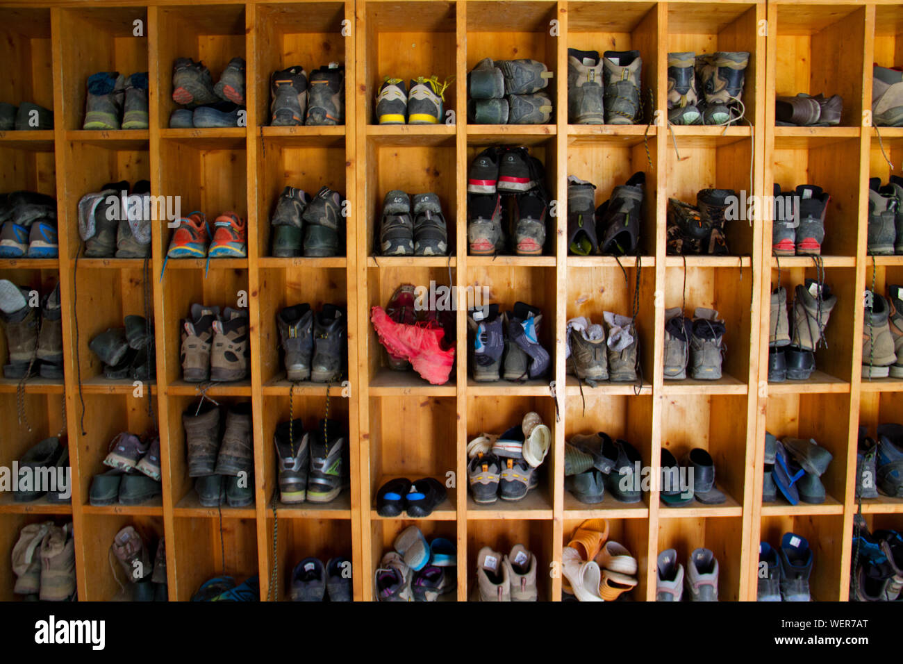 Collection of hiking boots in a mountain cabin in the Pyrenees Stock Photo
