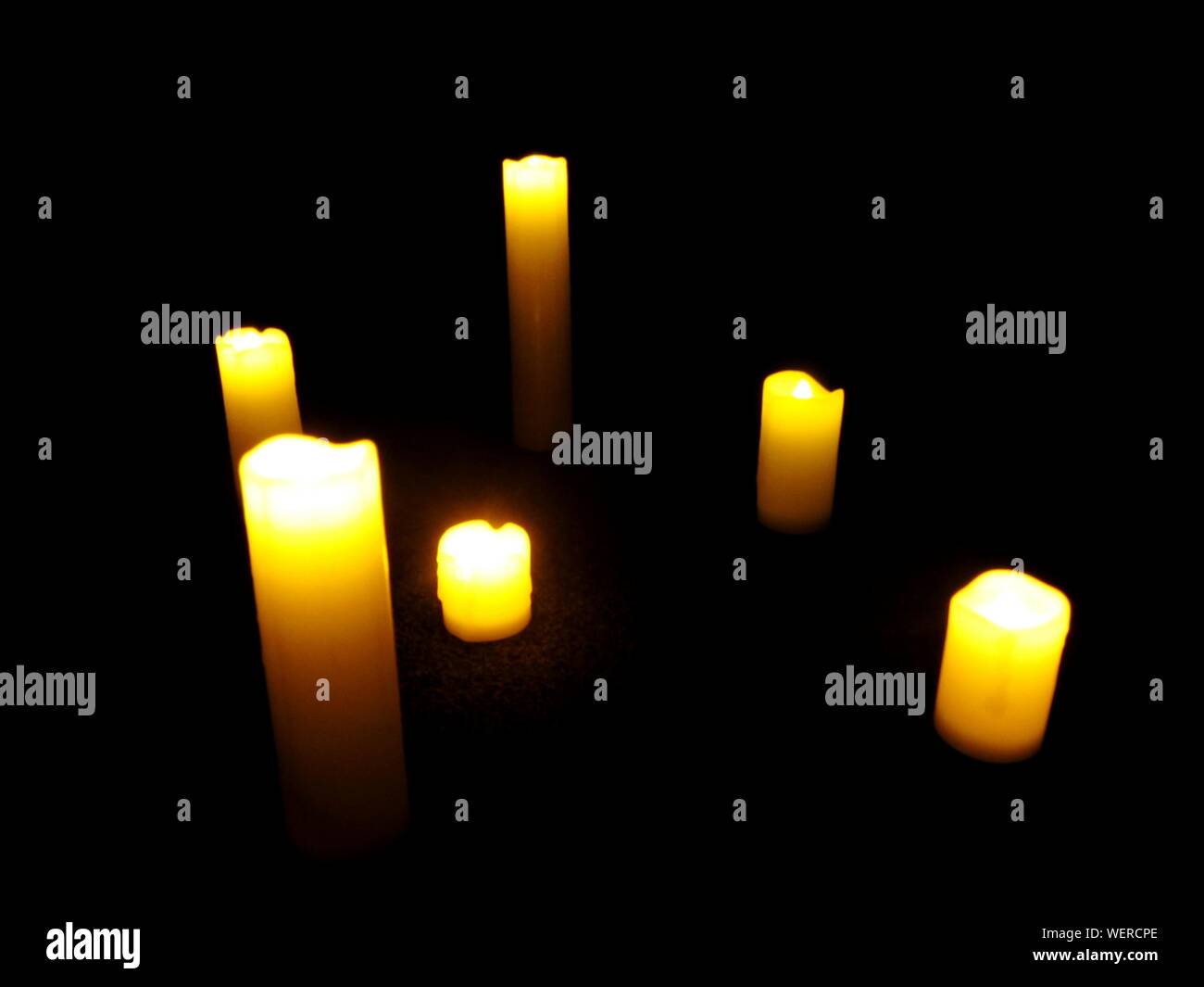 Candles Burning In Dark Room Stock Photo Alamy