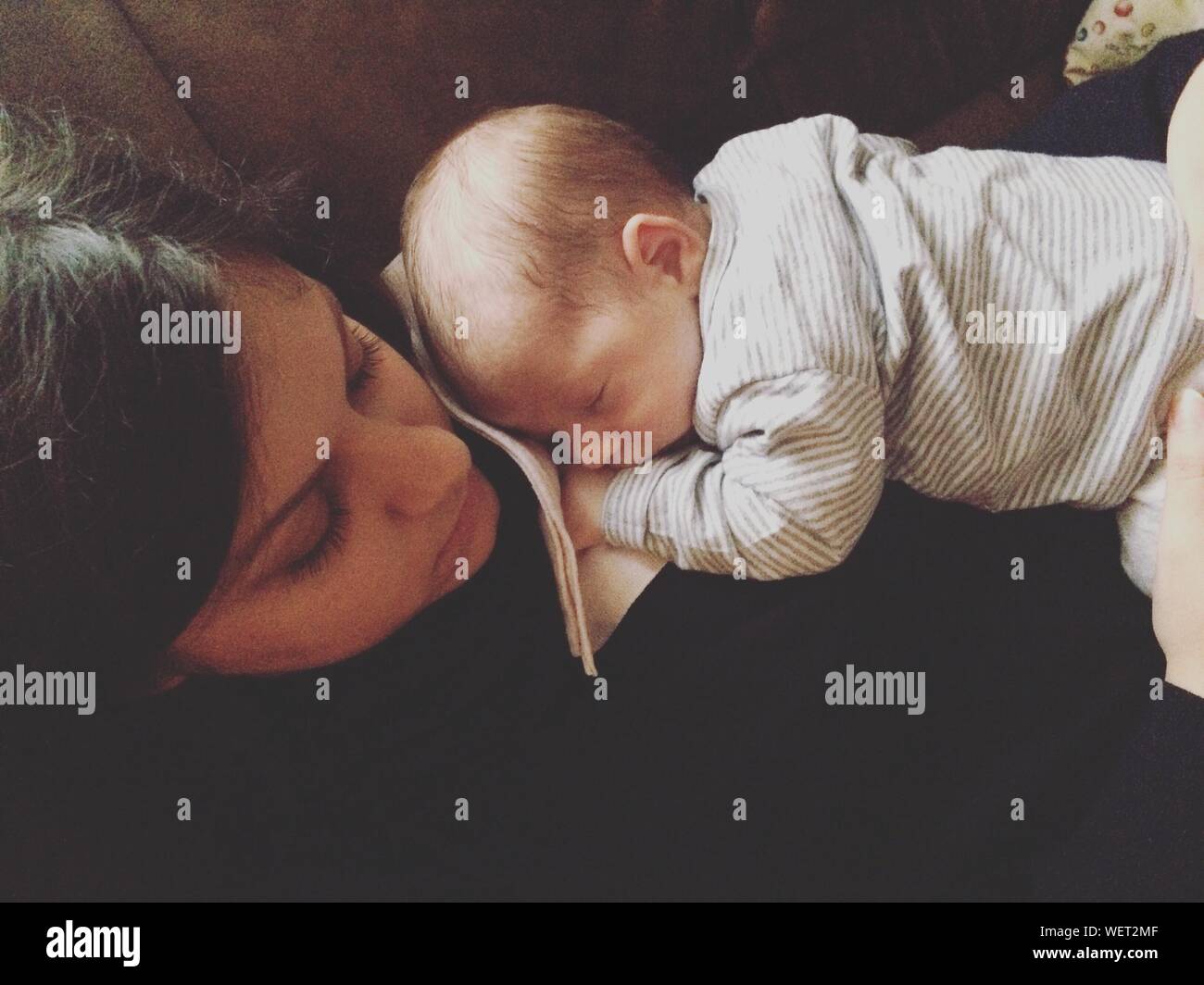 Baby resting on mother hires stock photography and images Alamy