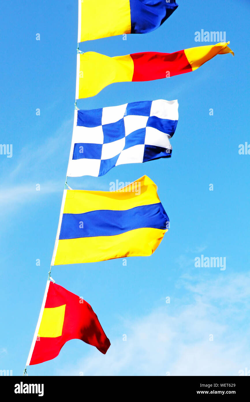 Marine signal flags on a clear blue sky background taken closeup Stock ...