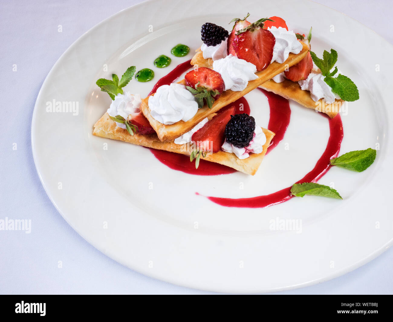 Close-up Of Puff Pastries With Strawberries Served In Plate On Table Stock Photo