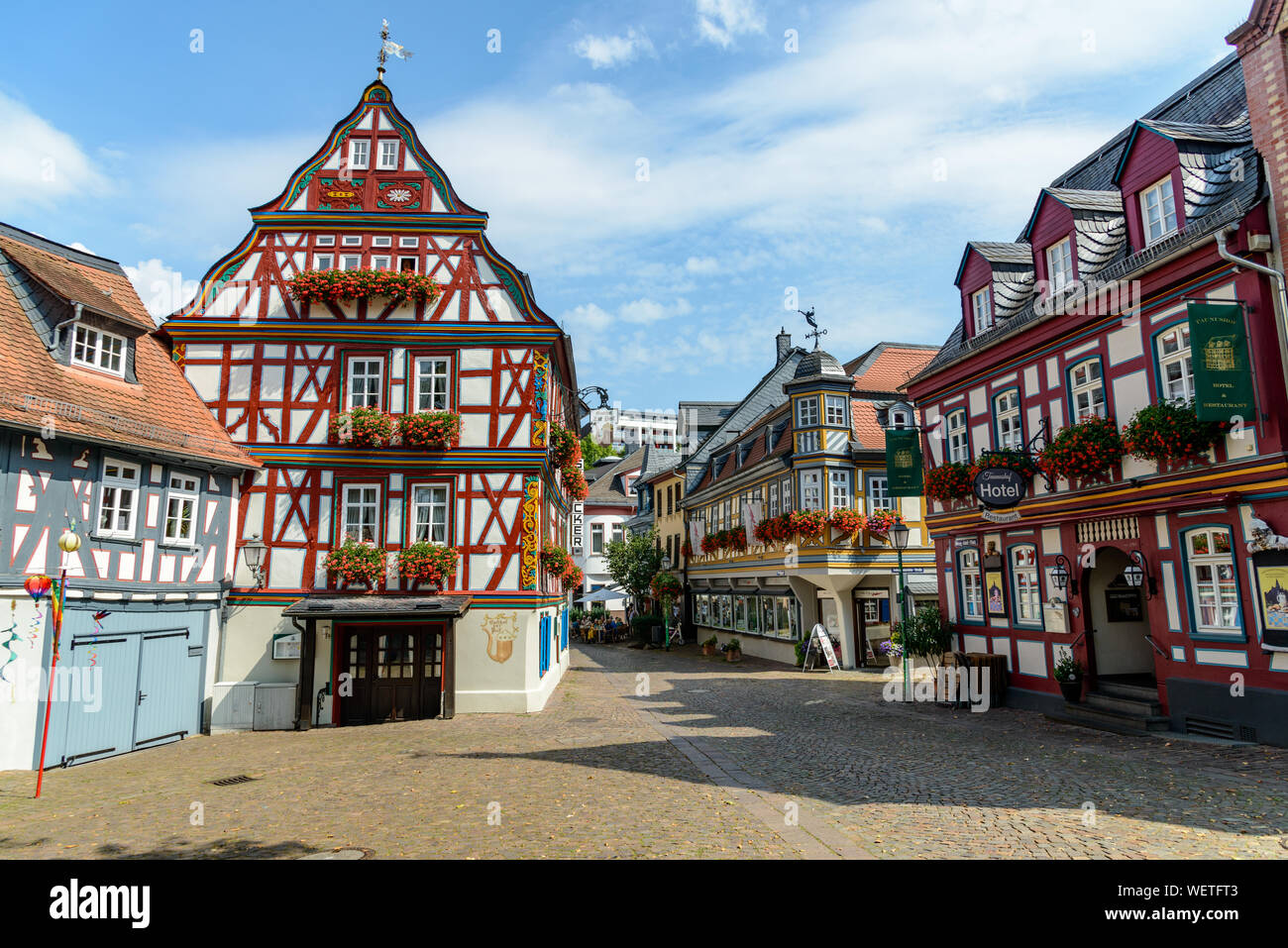 29 August 2019: Colorful Half-timbered (Fachwerkhaus) house, houses, Hotel, restaurant nearby marketplace in Idstein, Hessen (Hesse), Germany. Nearby Stock Photo