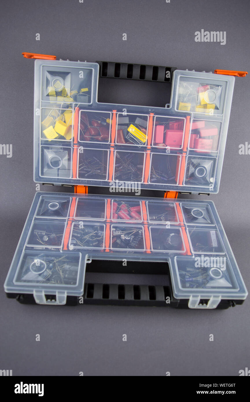 Electronic components capacitors stacked in a plastic folding case Stock Photo