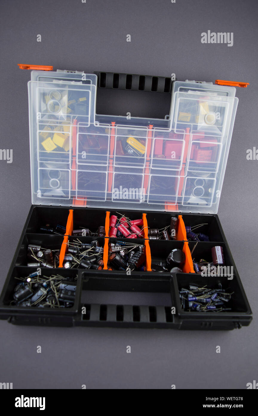 Electronic components capacitors stacked in a plastic folding case Stock Photo
