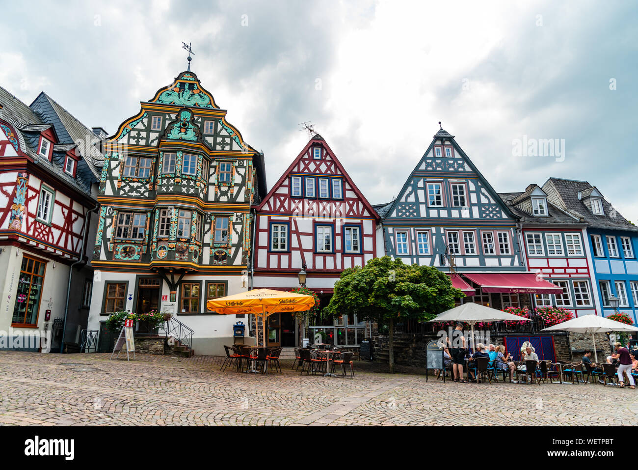 29 August 2019: Colorful Half-timbered (Fachwerkhaus) house, houses, cafe, restaurants, peaple on marketplace in Idstein, Hessen (Hesse), Germany. Nea Stock Photo