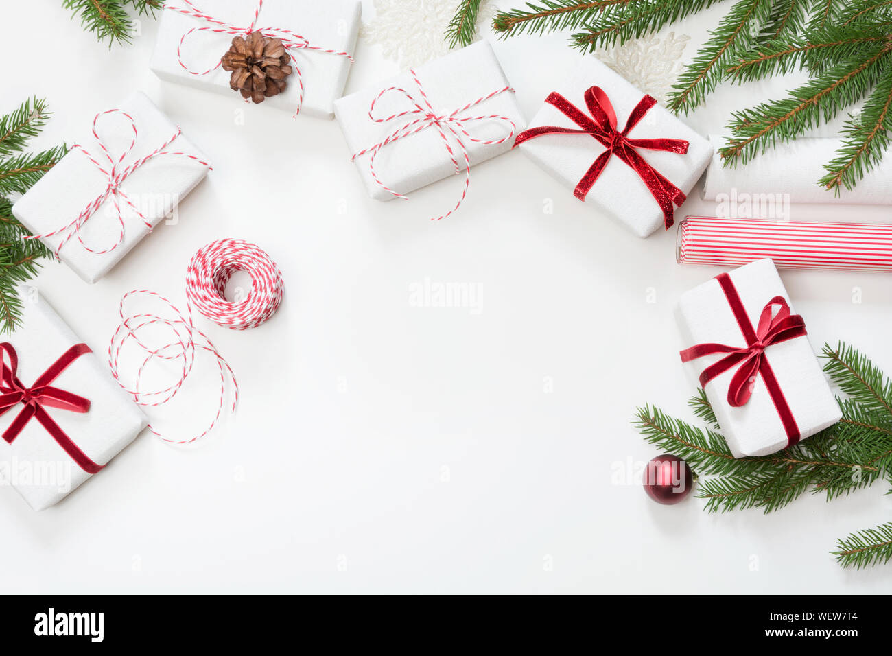 Christmas gift boxes wrapped in white craft paper and decorative red ...