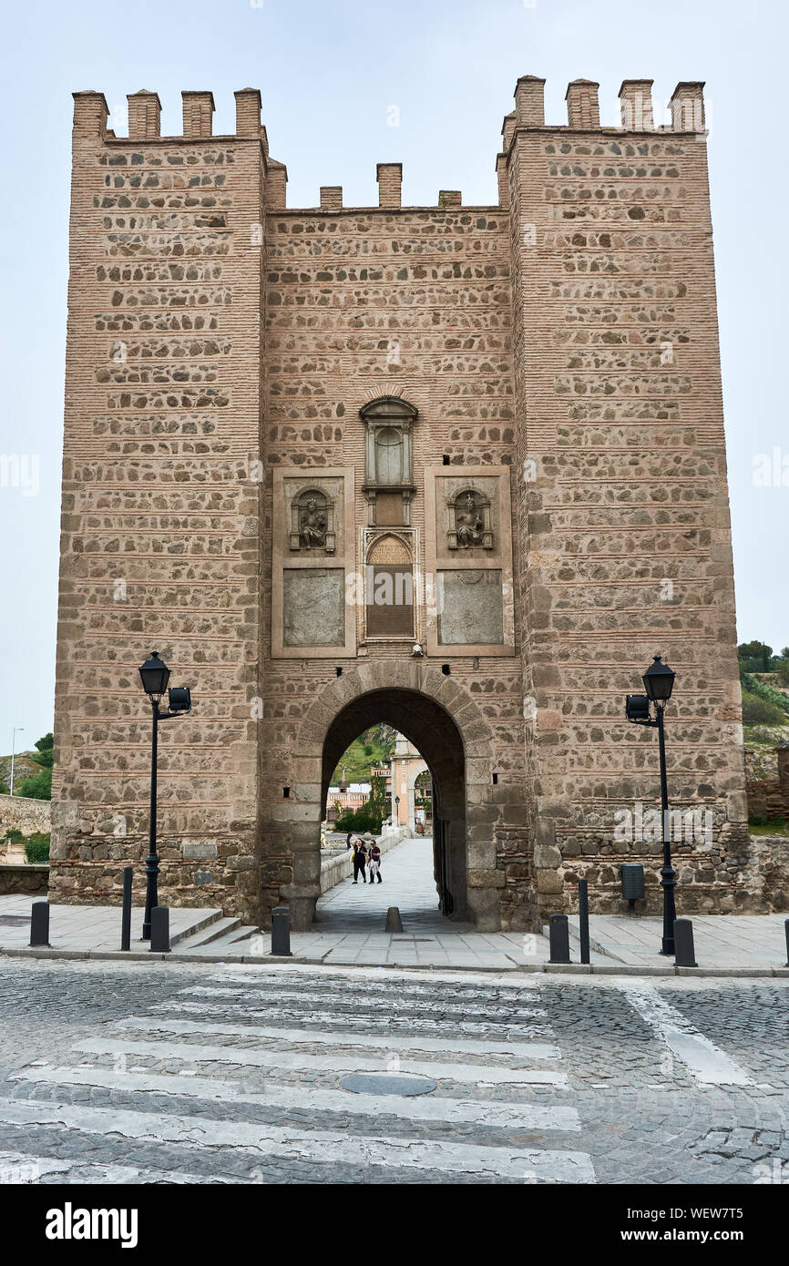 TOLEDO, SPAIN - APRIL 24, 2018: Tower with gate of the Alcantara bridge in Toledo. Stock Photo