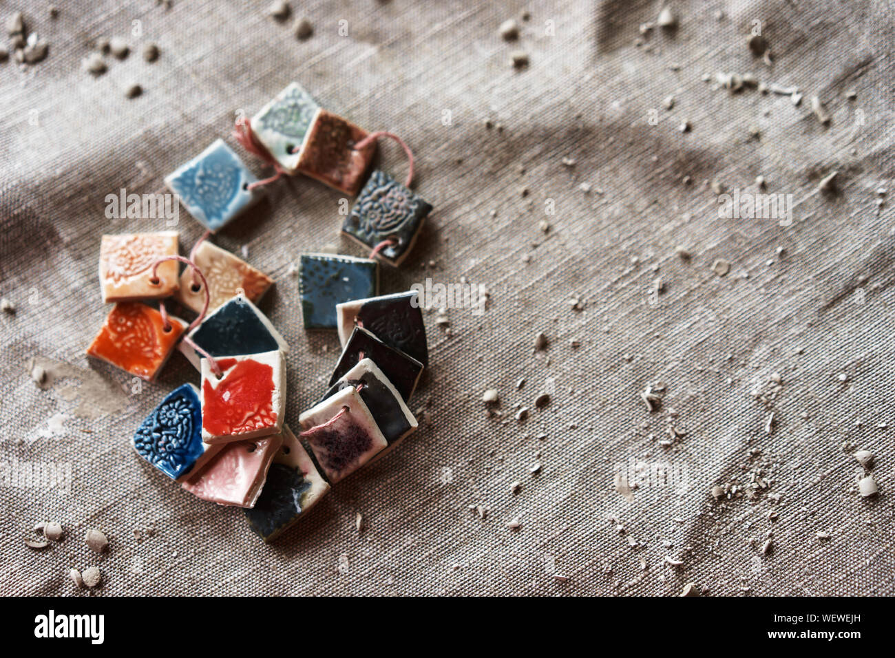 Small pieces of ceramics with samples of drawings and paints for