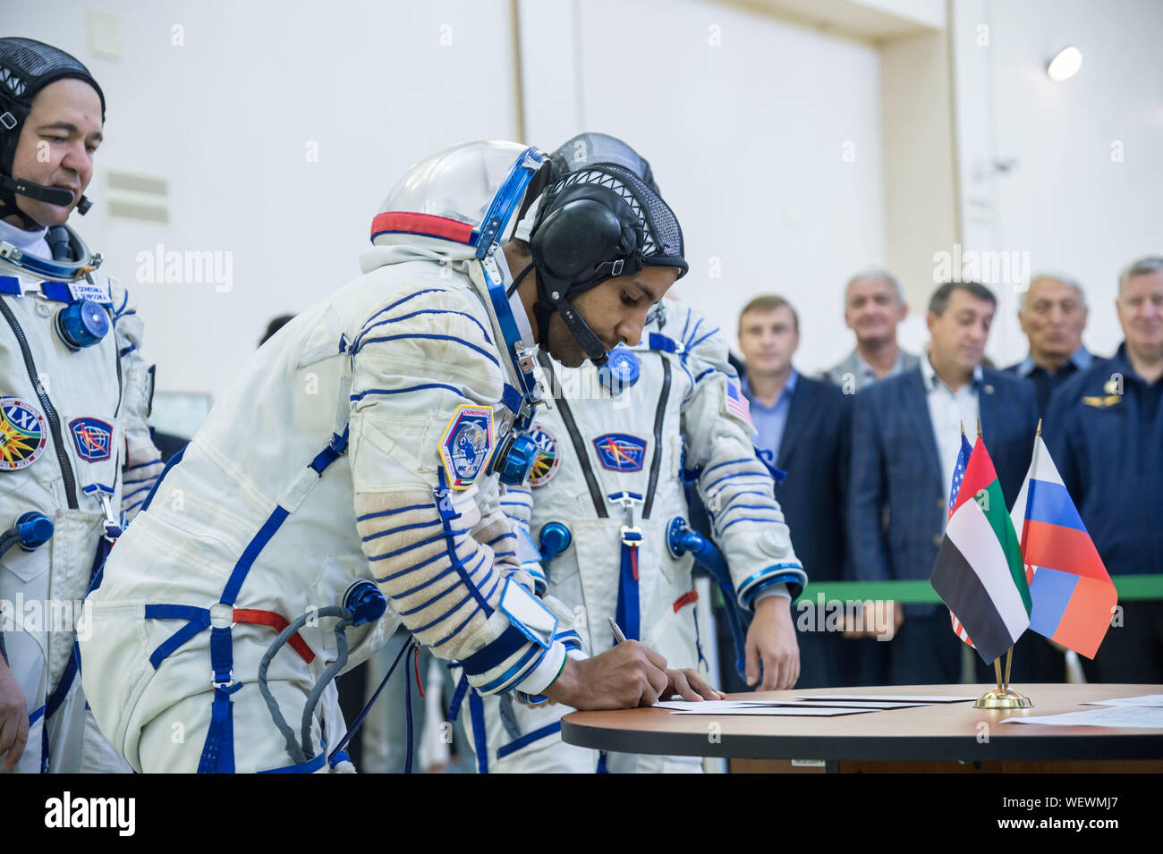 Star City, Russia. 30 August 2019. International Space Station Expedition 61 spaceflight participant Hazzaa Ali Almansoori of the United Arab Emirates in his Sokol space suit signs in for the final crew qualification exams at the Gagarin Cosmonaut Training Center August 30, 2019 in Star City, Russia. Expedition 61-62 is expected to launch to the International Space Station on September 25, 2019. Credit: NASA/Planetpix/Alamy Live News Stock Photo
