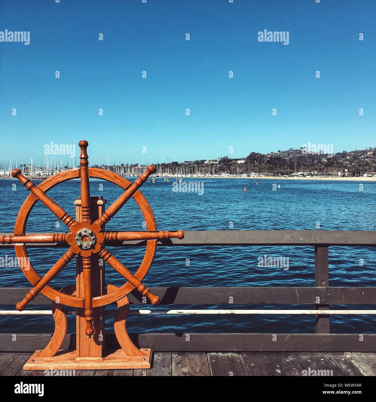 Wooden Helm On Pier Against Sea Stock Photo