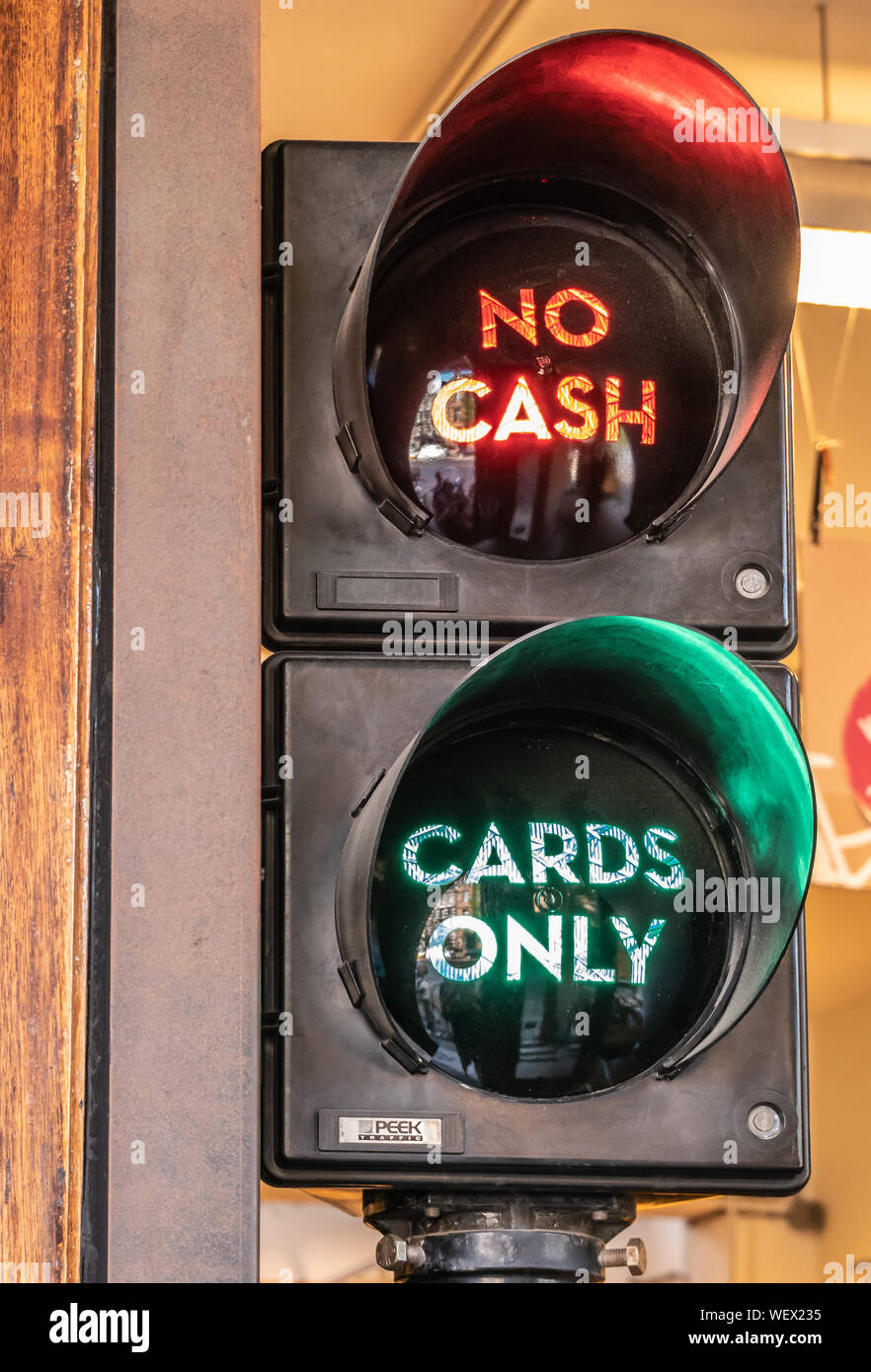 Amsterdam, the Netherlands - July 1, 2019: Closeup of traffic light displaying two options at check-out in retail store: no cash om red, cards only in Stock Photo