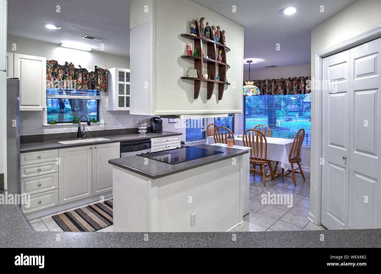 Simple white dated kitchen with island Stock Photo Alamy