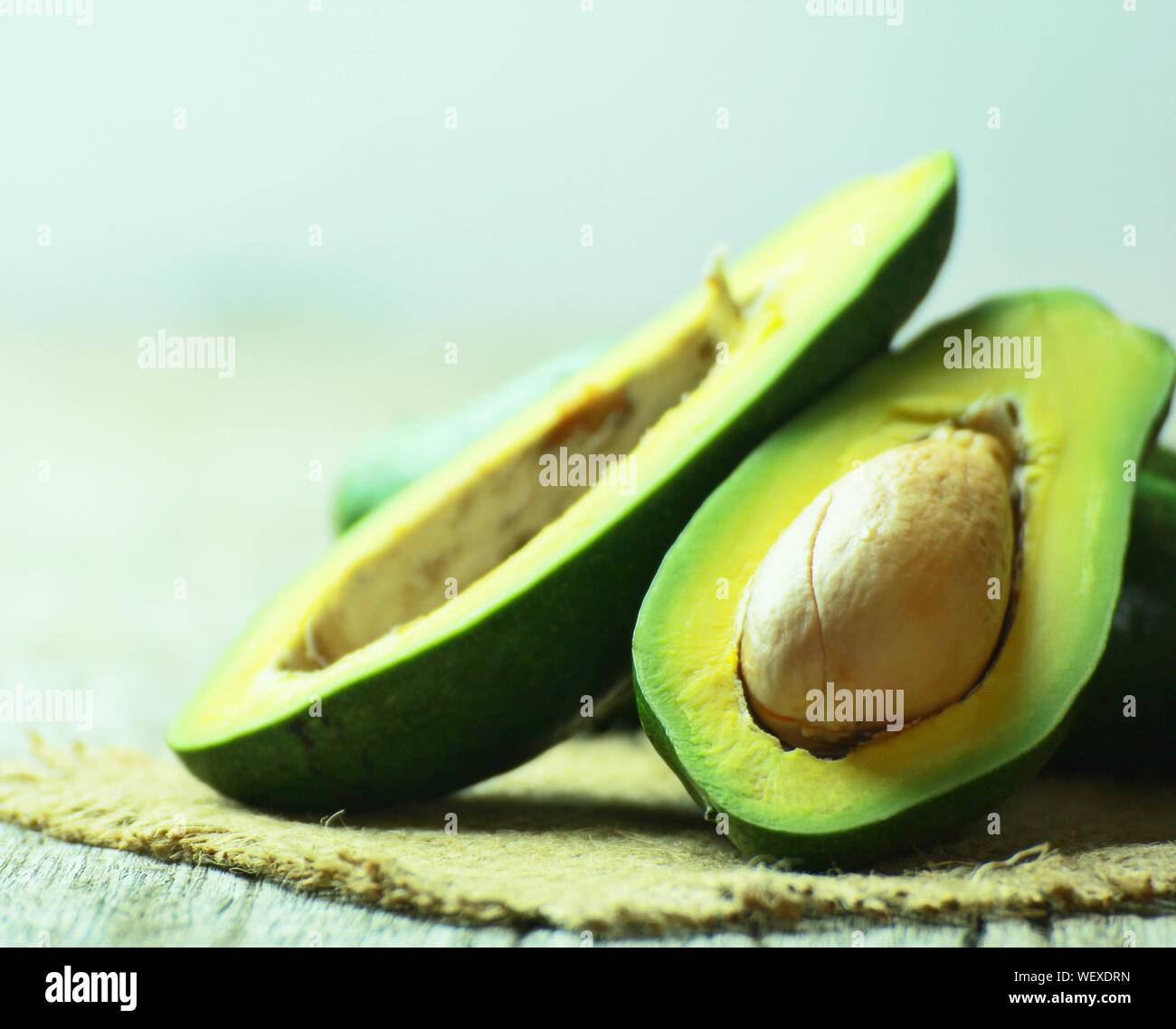 Close-up Of Halved Avocados On Table Stock Photo
