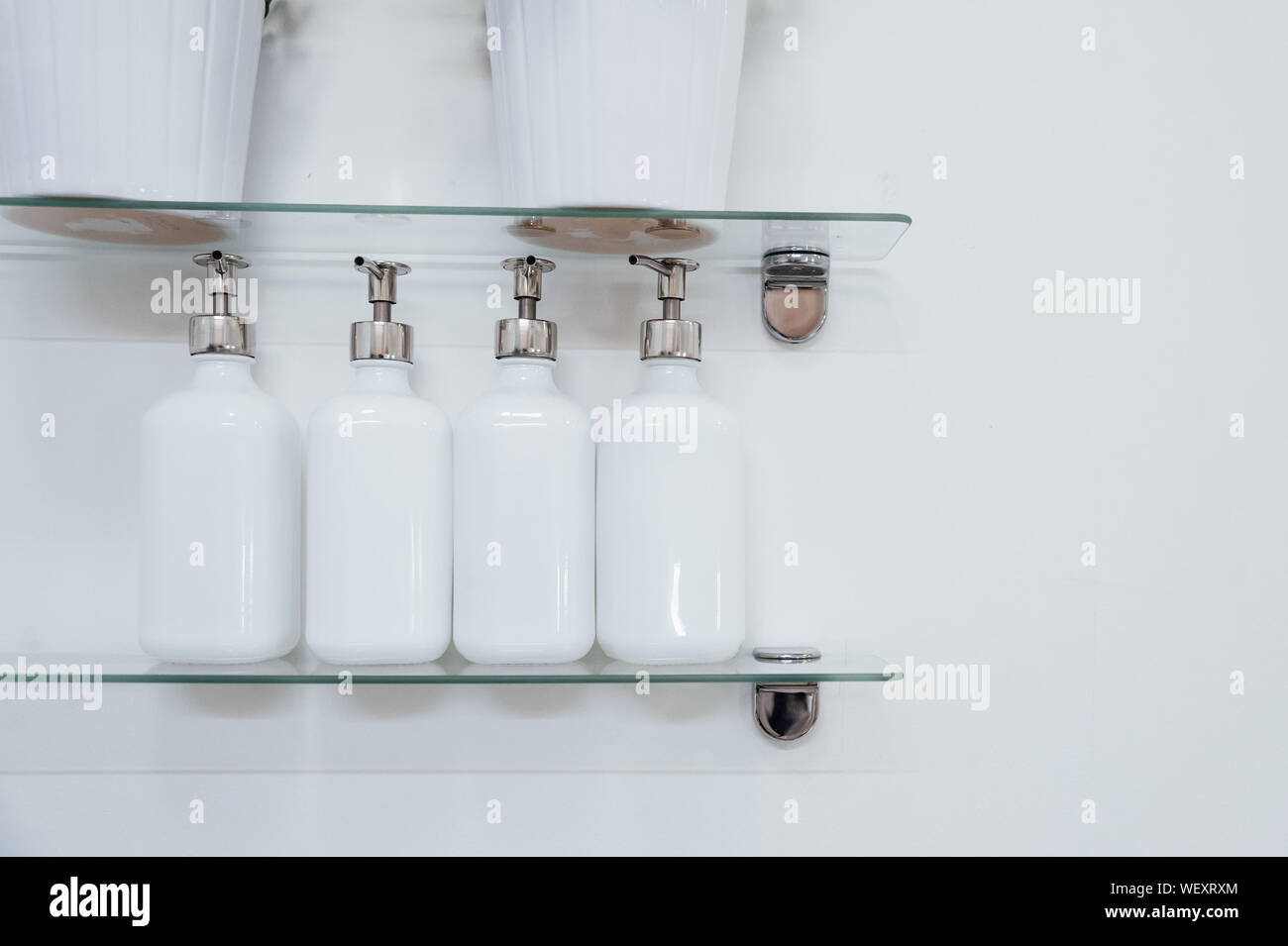 Close-up Of Soap Dispensers On Shelves Stock Photo