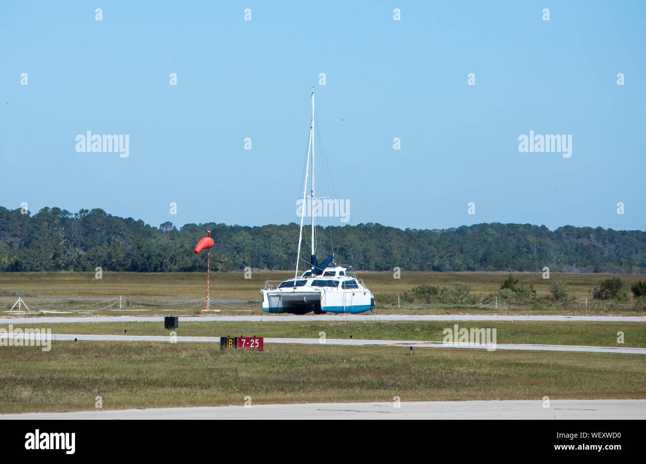 Catamaran sitting on a runway after storm surge from Hurricane Matthew Stock Photo