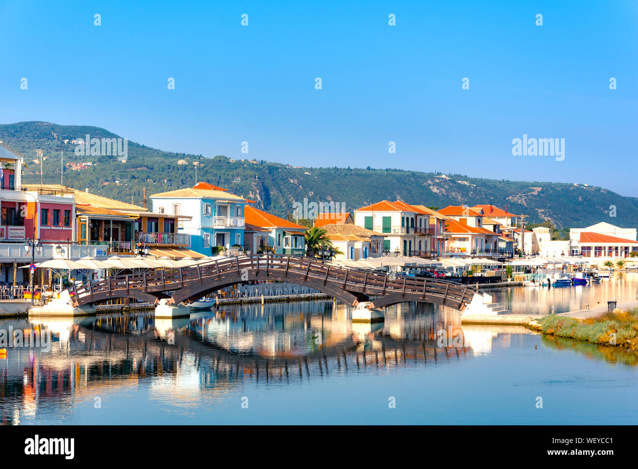 Lefkas (Lefkada) town, amazing view at the small marina for the fishing boats with the nice wooden bridge and promenade, Ionian island, Greece Stock Photo