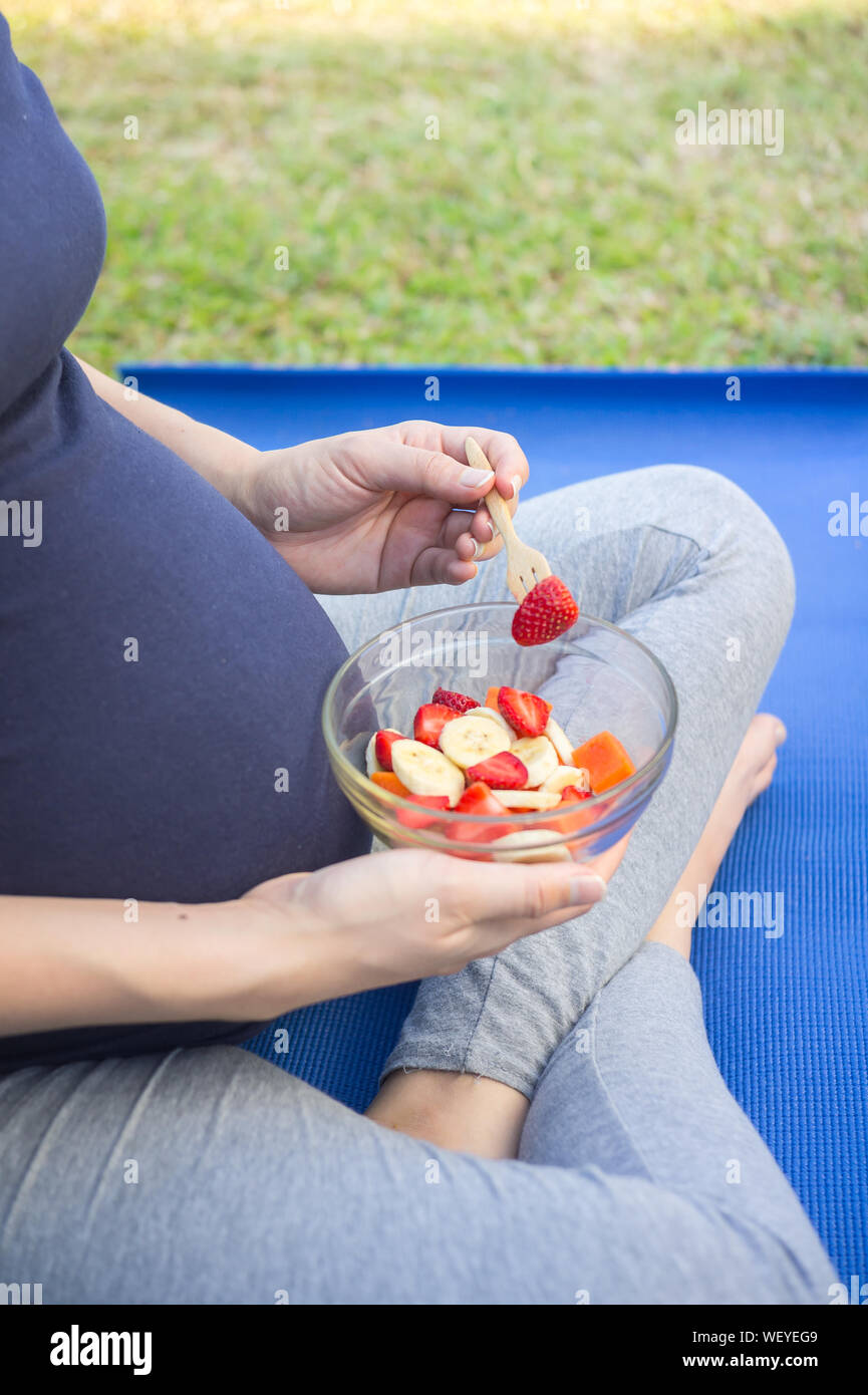 Pregnant woman eating banana hires stock photography and images Alamy