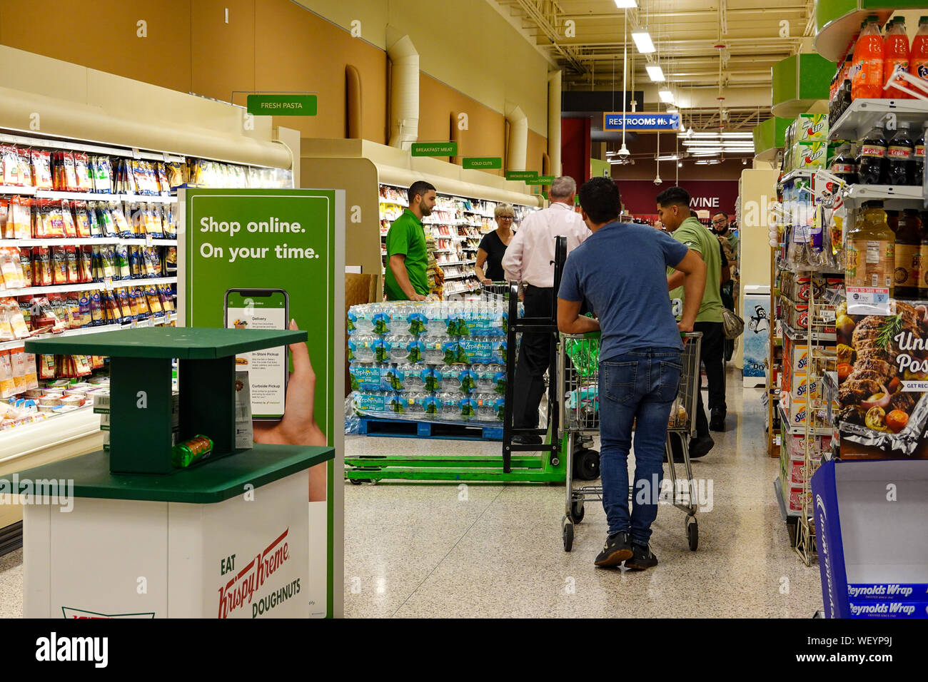 Orlando,FL/USA-8/30/19: Grocery store employees handing out rationed bottles of water. Stock Photo