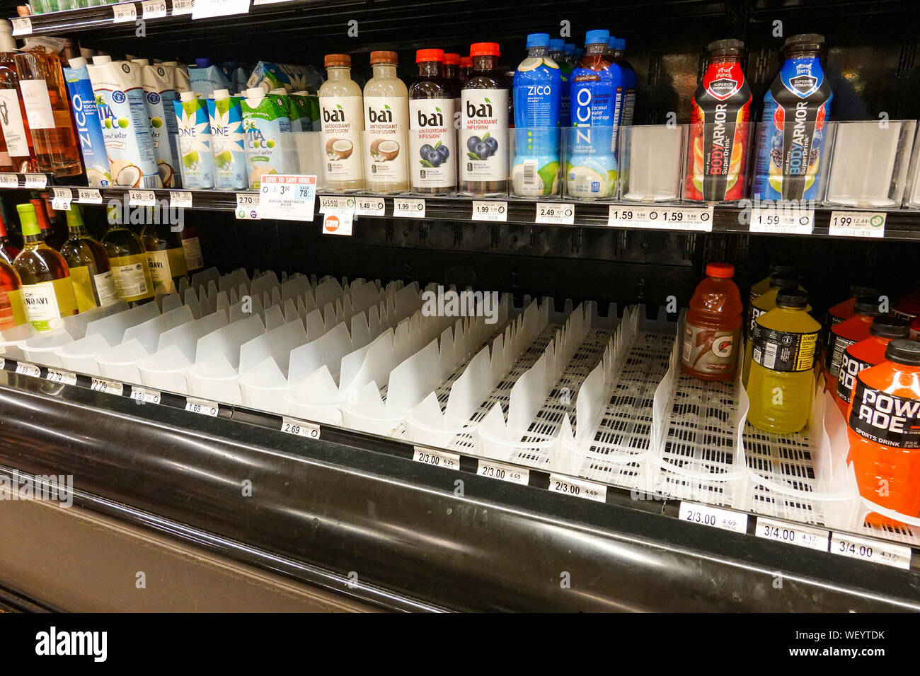 Orlando,FL/USA-8/30/19: Empty grocery store shelves of bottled water before a hurricane or snow storm. Stock Photo