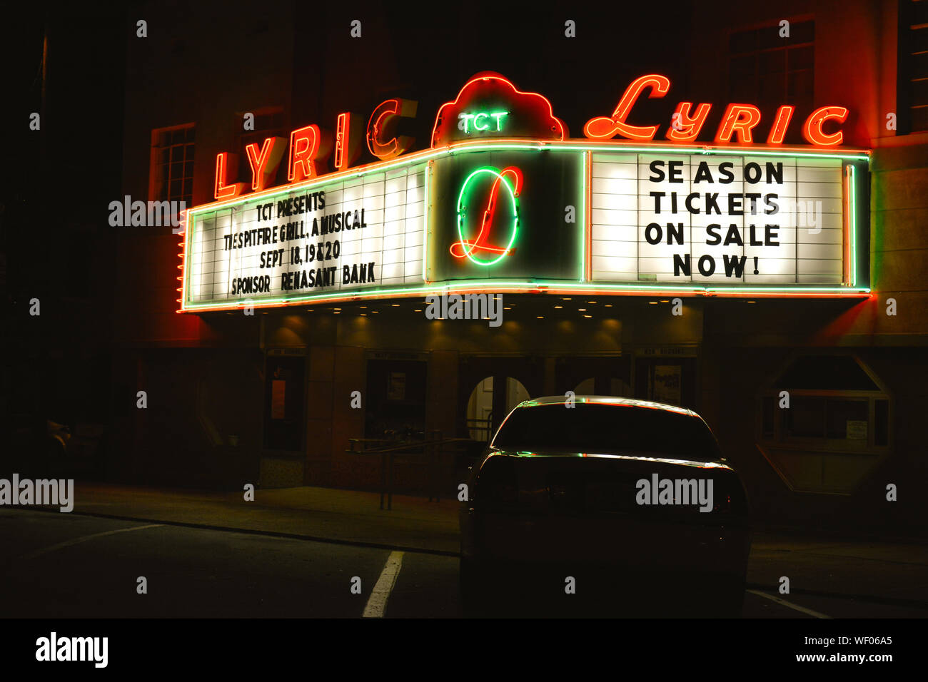 A nostalgic view of a vintage movie theater, The Lyric, with neon