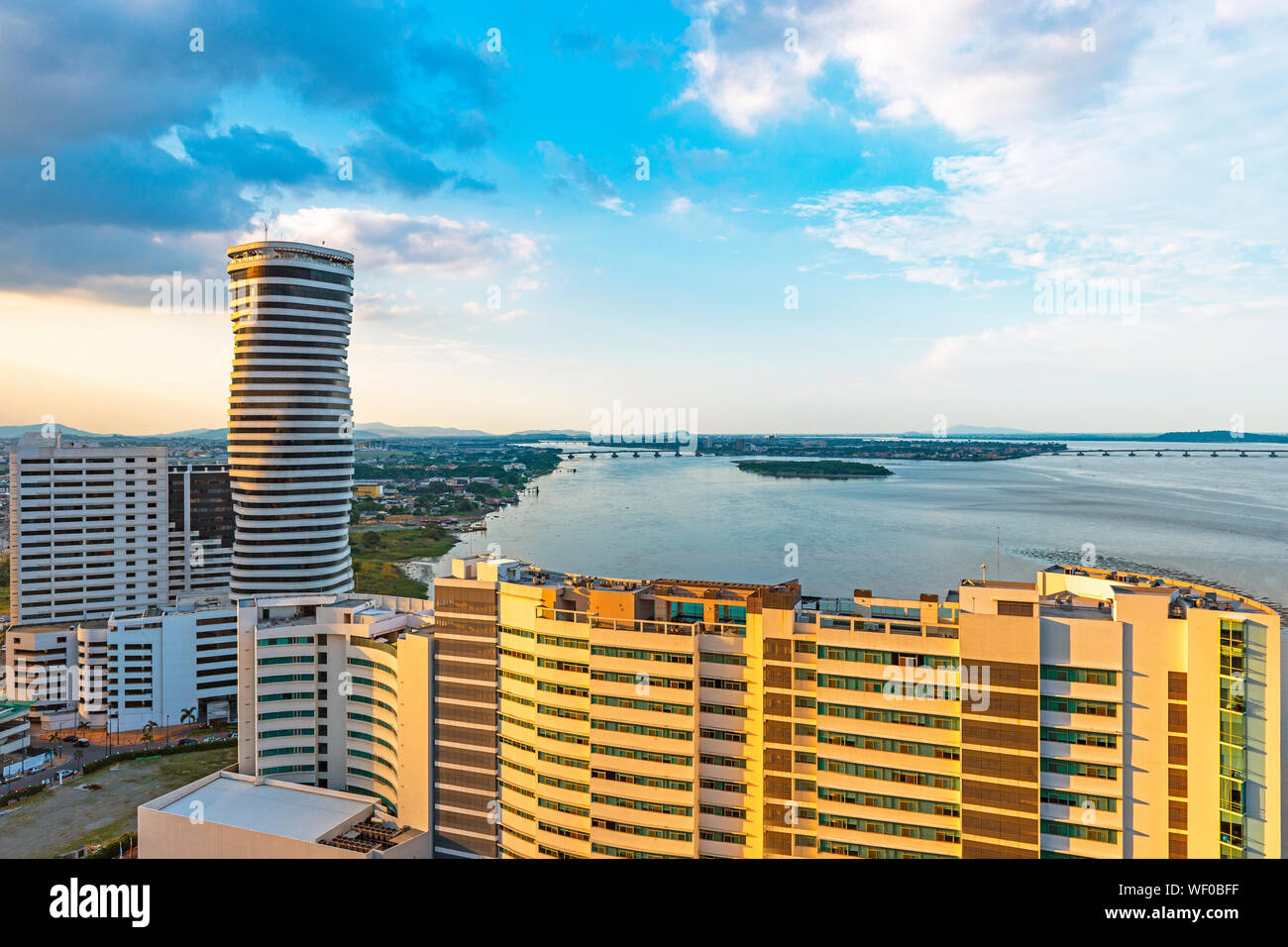 Urban skyline of Guayaquil city and its skyscrapers by the river Guayas at sunset, Ecuador. Stock Photo