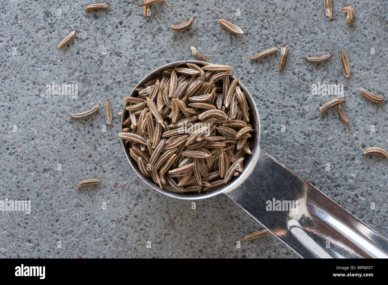 High Angle View Of Cumin Seeds In Teaspoon Stock Photo