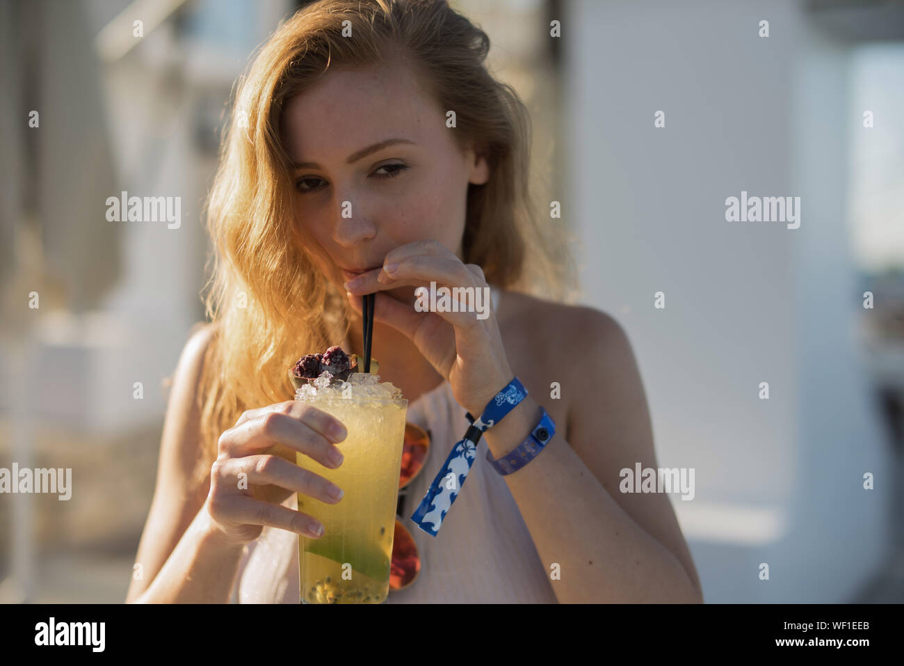 Portrait Of Young Woman Drinking Cold Drink Stock Photo