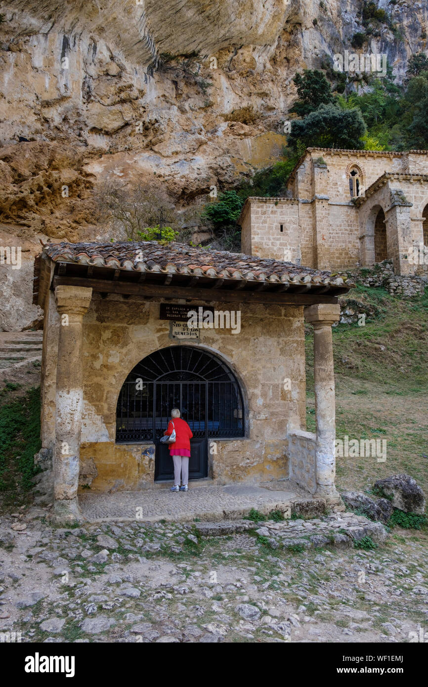 Female visitor at the old Ermita de Santa María de la Hoz in the village of  Tobera, Burgos Province, Spain Stock Photo