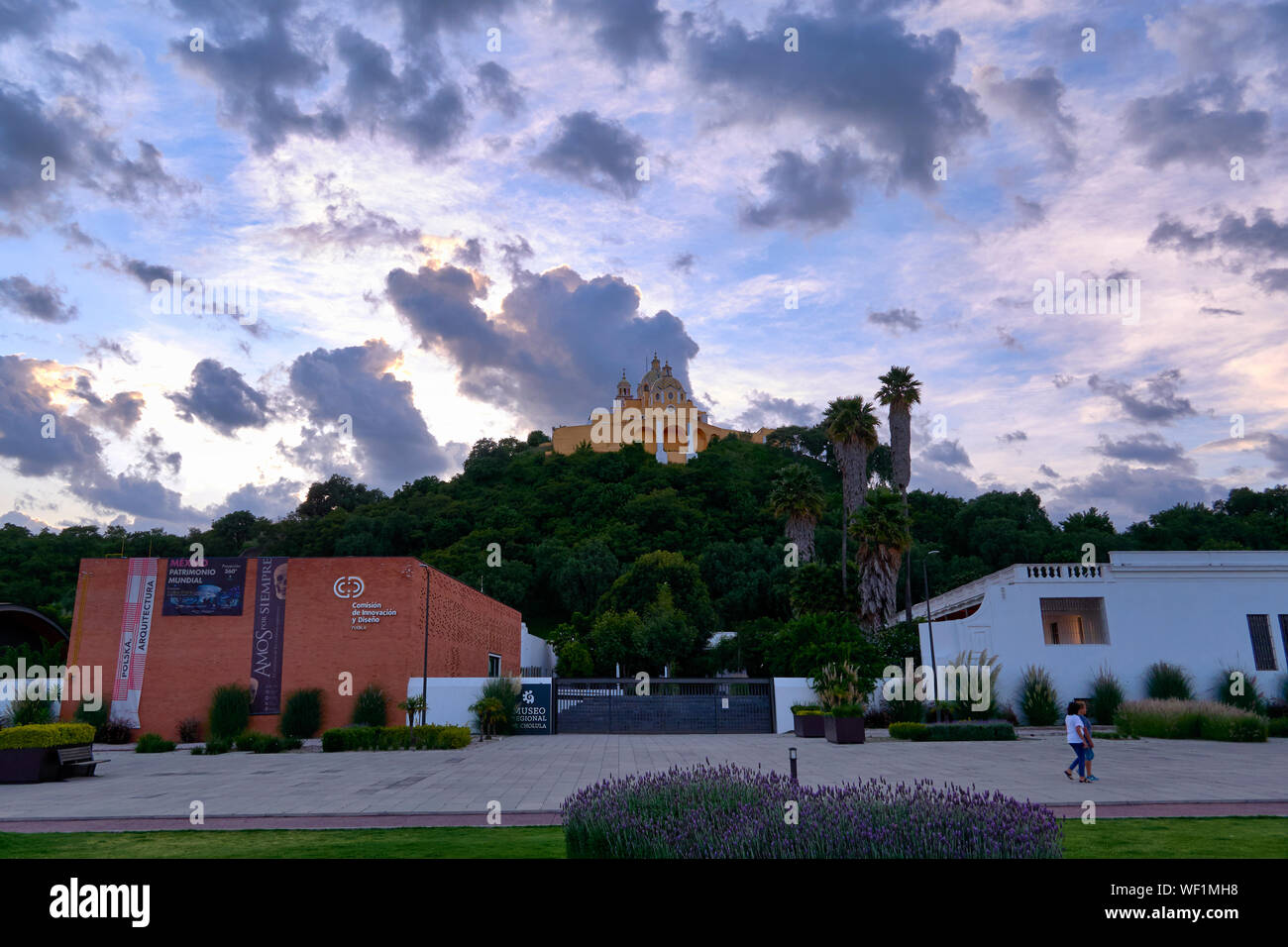 San Andres Cholula, Mexico, August 30, 2019 - Shrine of Our Lady of Remedies and Regional Museum of Cholula with clouds at sunset seen from the Jardin San Andres Cholula. Stock Photo