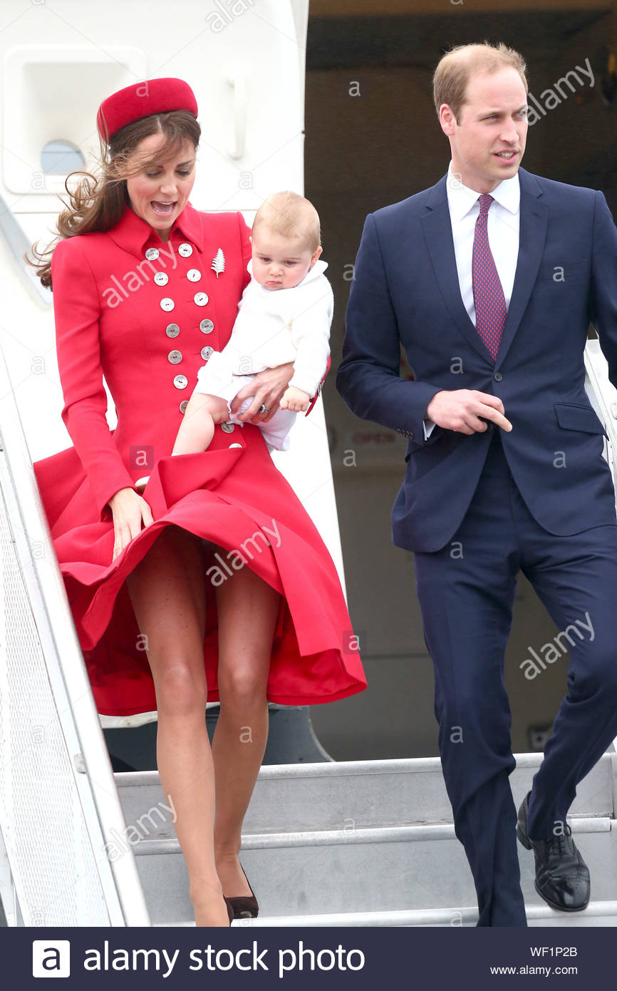 wellington-new-zealand-prince-william-and-kate-middleton-arrive-in-wellington-with-their-baby-prince-george-to-commence-their-royal-tour-of-new-zealand-the-royal-family-touched-down-at-wellington-military-terminal-after-flying-on-a-new-zealand-royal-airforce-plane-from-sydney-despite-the-windy-arrival-the-duchess-of-cambridge-looked-stunning-in-a-flowy-red-dress-and-matching-hat-and-carrying-her-precious-cargo-in-tow-akm-gsi-april-7-2014-WF1P2B.jpg