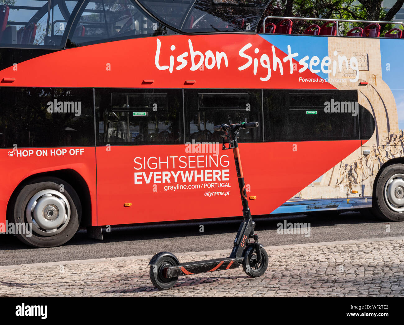 Circ electric scooter by Hop on Hop off bus in Lisbon park Stock Photo