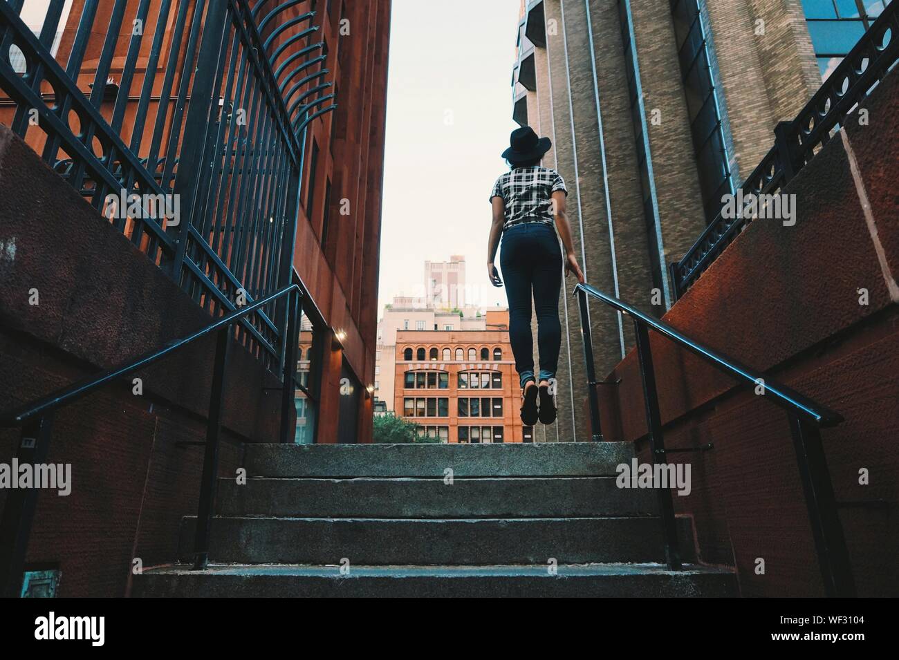 Woman walking stairs building hi-res stock photography and images - Alamy