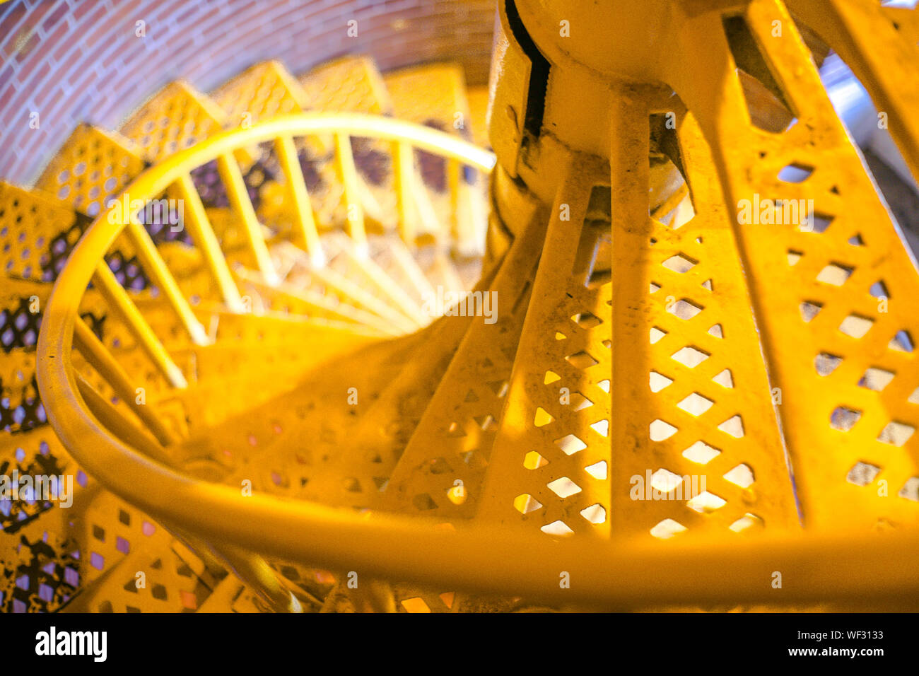 Close Up Of Yellow Spiral Stairs Stock Photo